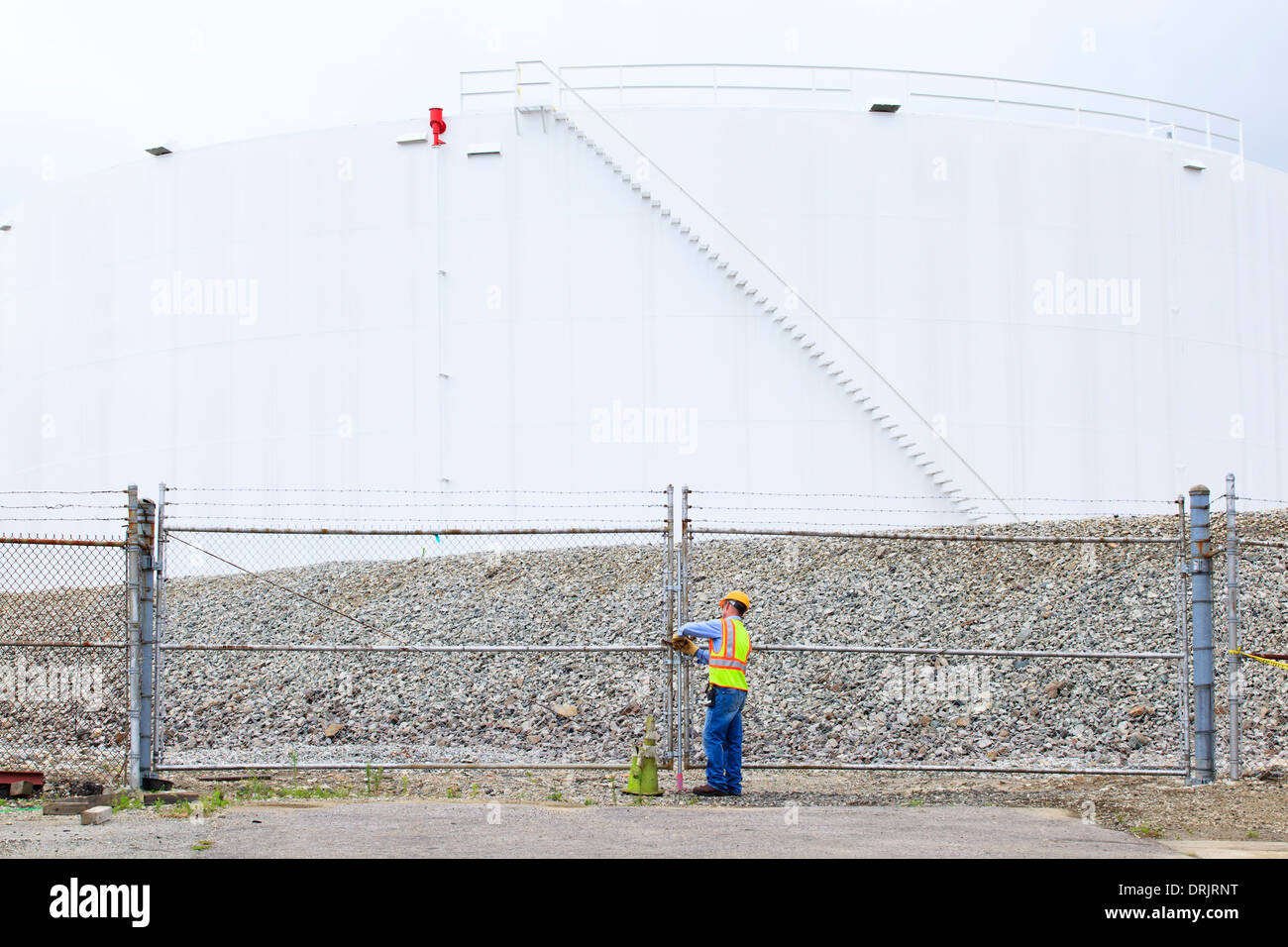 Engineer entering fuel storage tank depot Stock Photo Alamy