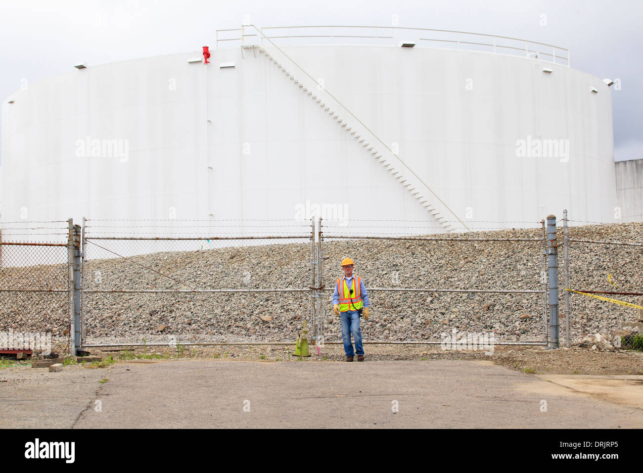 Engineer standing in front of fuel storage tank depot Stock Photo Alamy