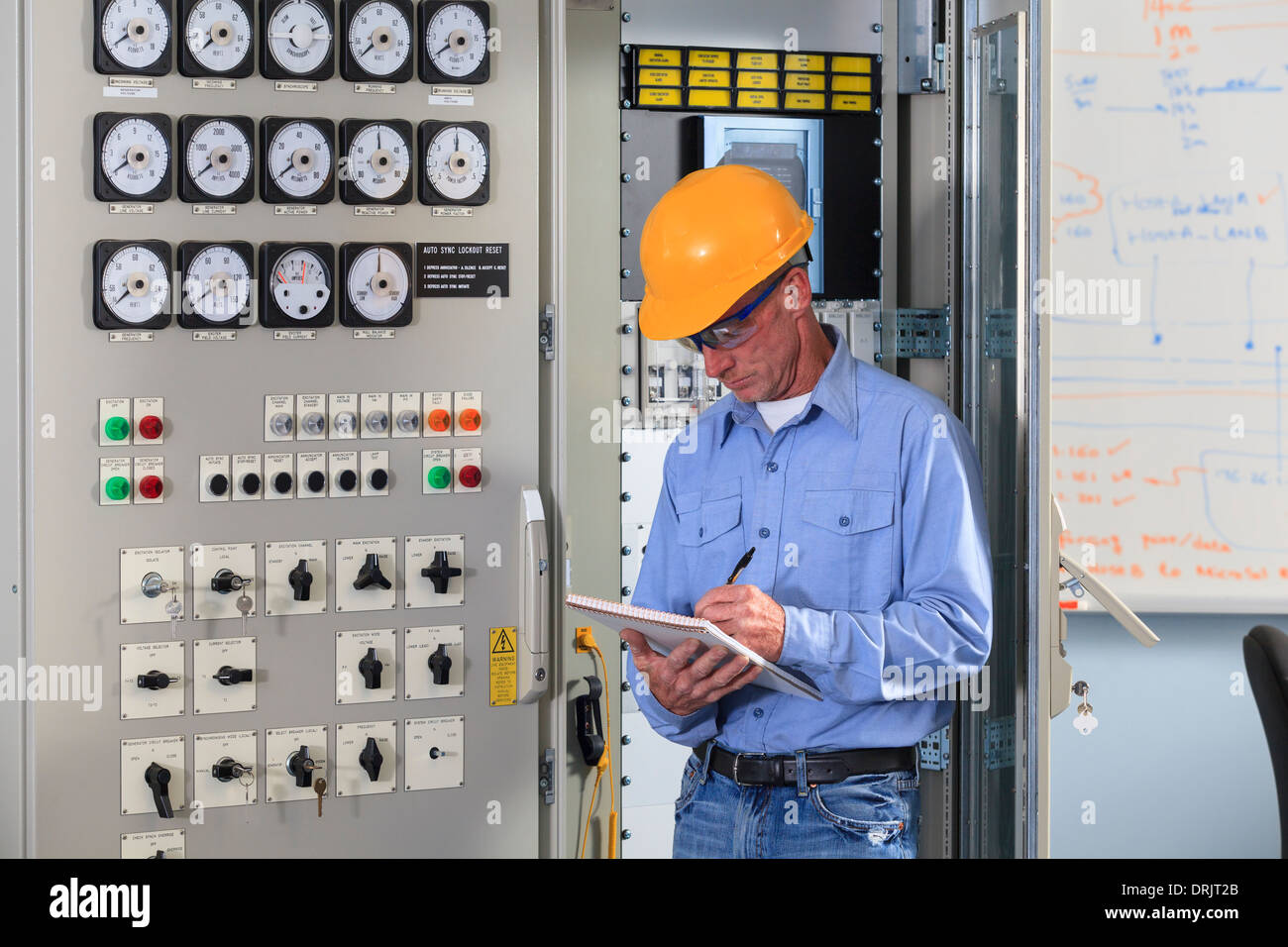 Electrical engineer inspecting power plant controls in central