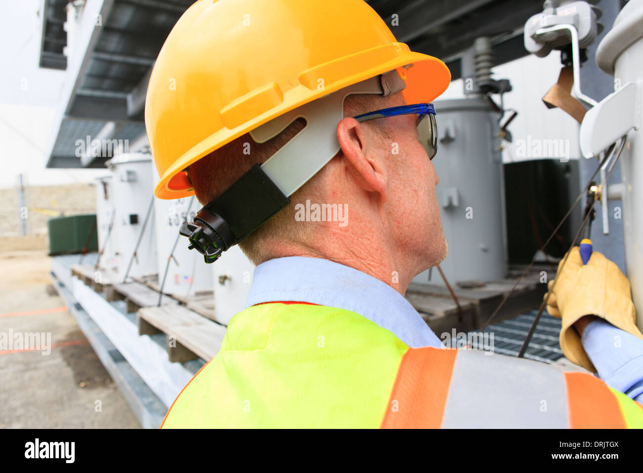 Engineer at electric power plant at storage area for transformers Stock Photo