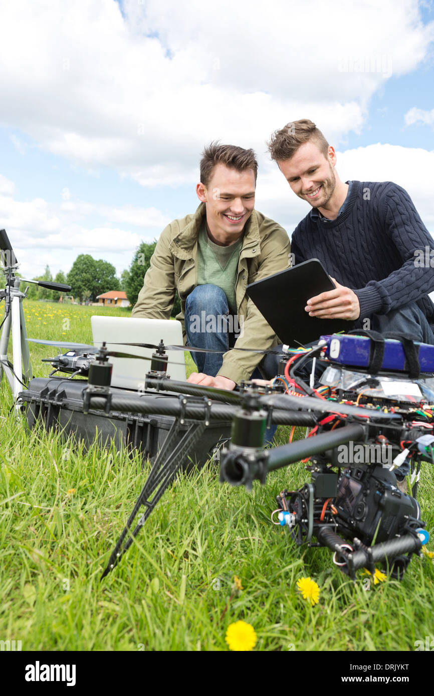 Technicians Discussing Over Digital Tablet By UAV Stock Photo