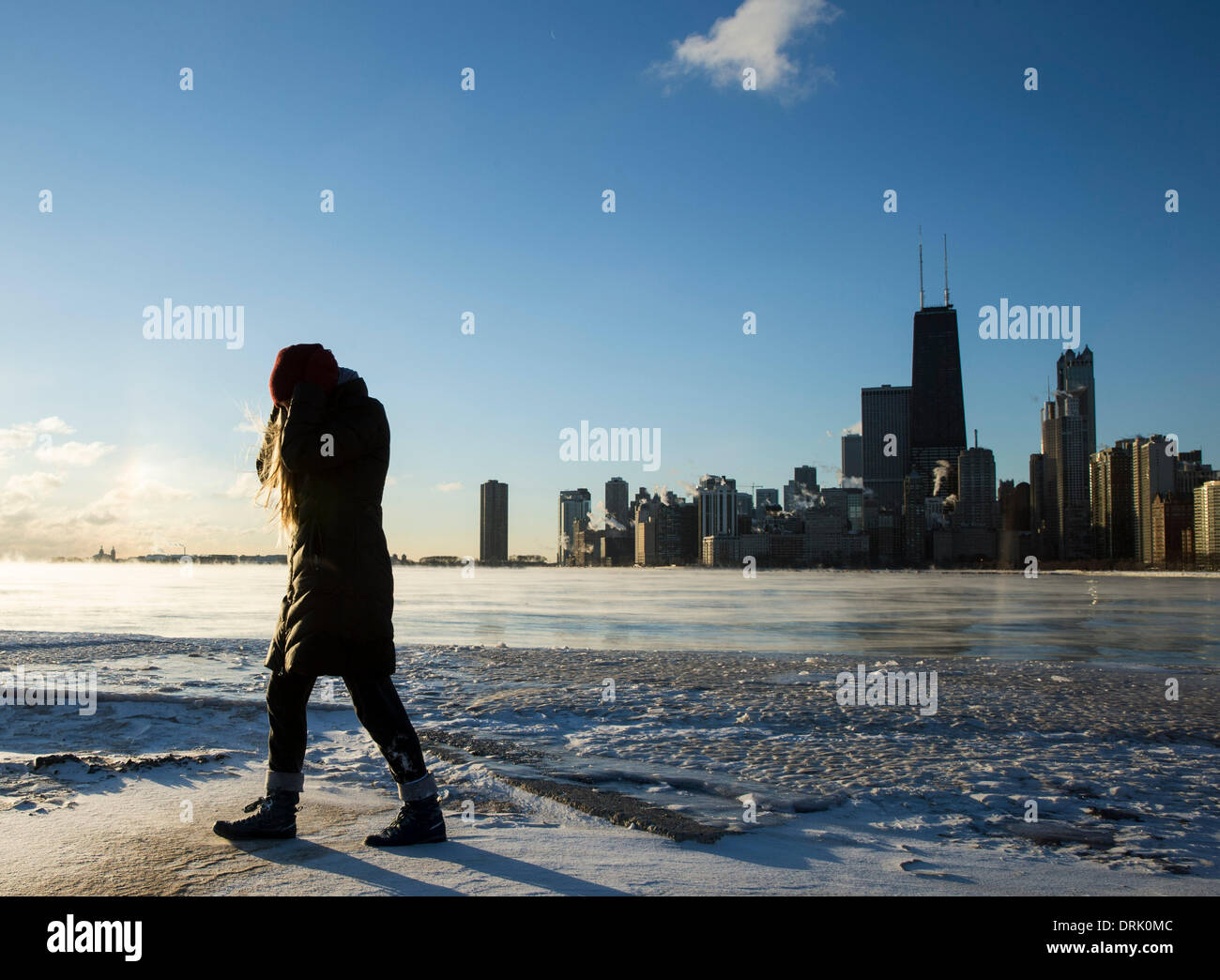 Chicago, Illinois, USA. 27th Jan, 2014. A girl walks by Lake Michigan in Chicago, the United States, on Jan, 27, 2014. A polar vortex swept midwest America Monday, bringing frigid temperatures with wind chill down to as low as -40 degrees. Credit:  Ting Shen/Xinhua/Alamy Live News Stock Photo