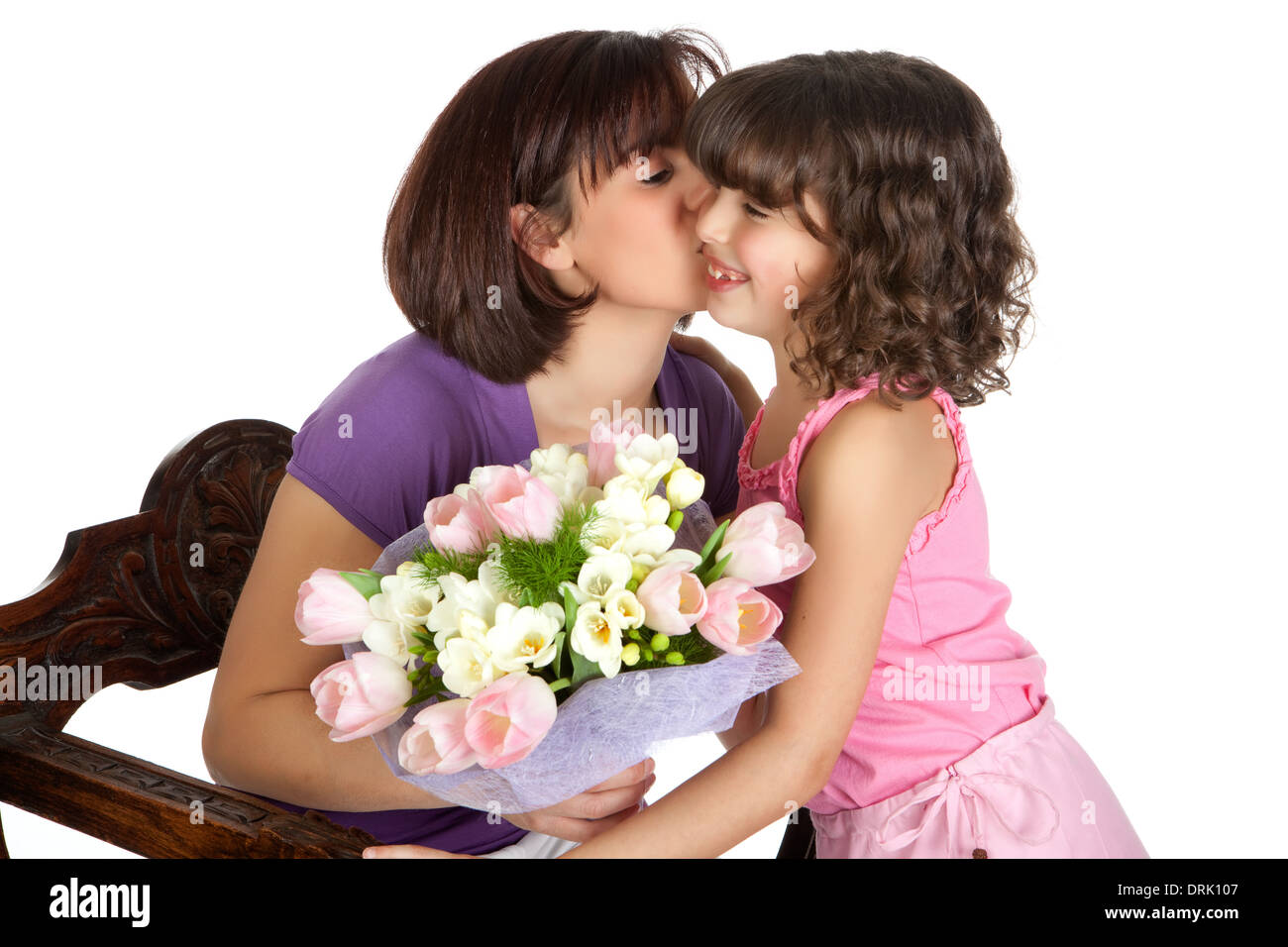 Happy mother kissing her daughter on mother's day Stock Photo