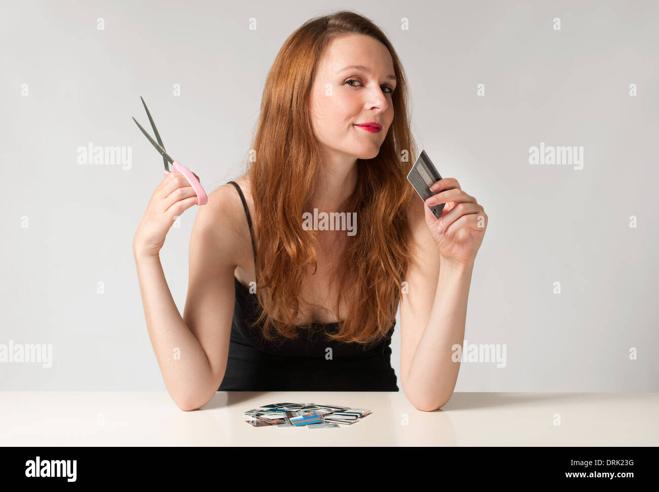 Woman holding a credit card ready to cut it with a scissors, financial freedom concept Stock Photo