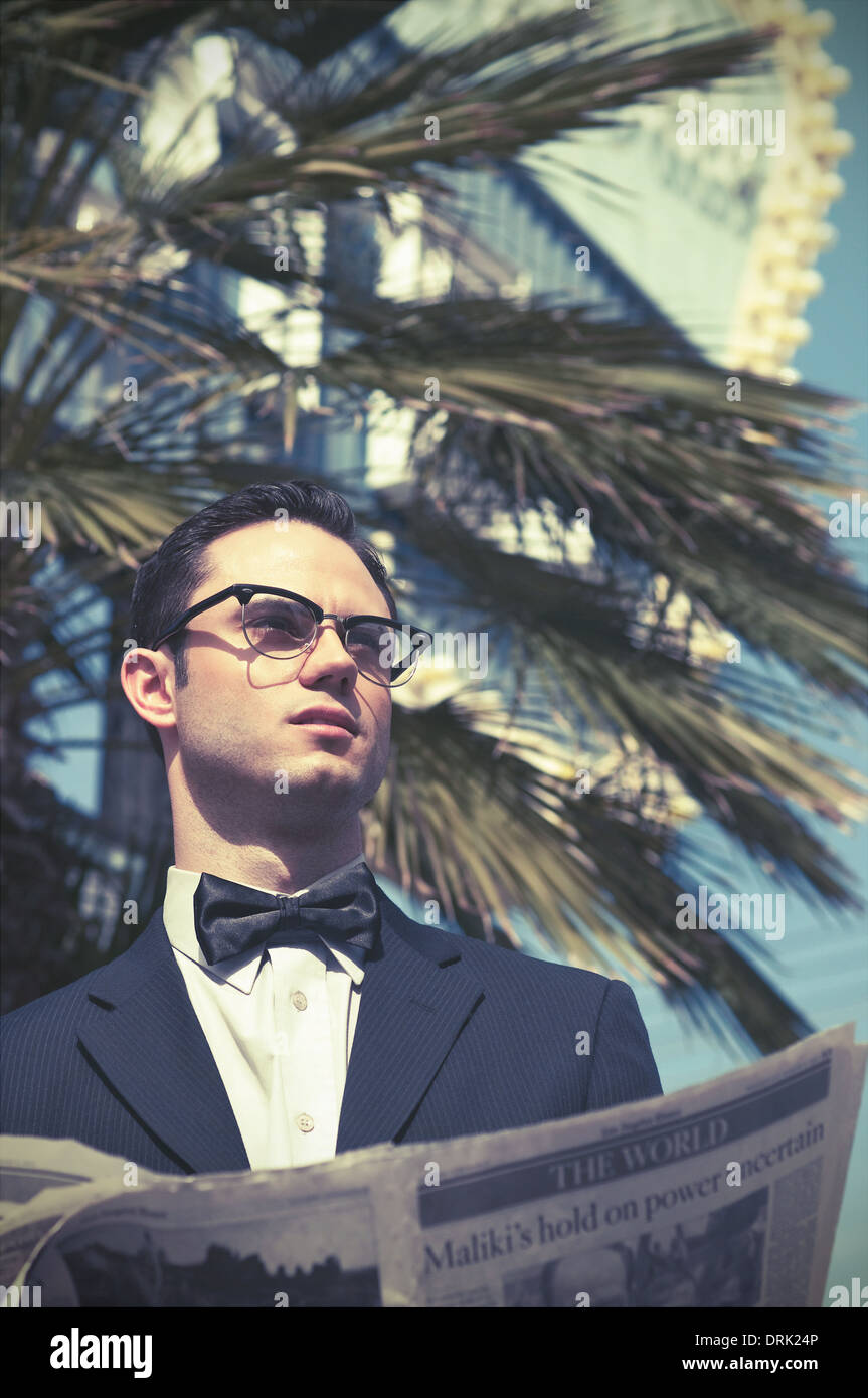 A young man, vintage portrait close up wearing suit and bow tie and 50s vintage glasses Stock Photo