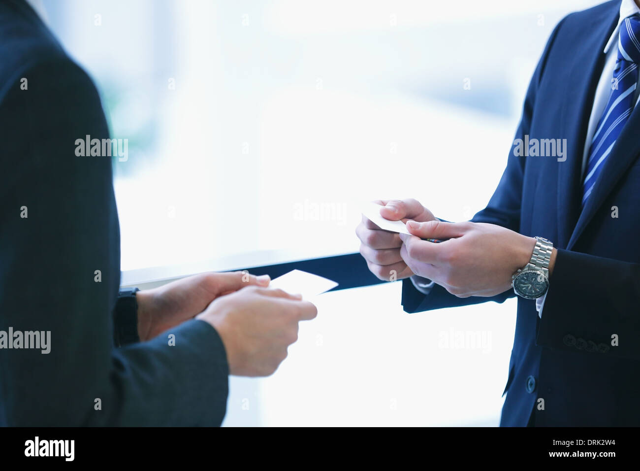 Businessmen exchanging name cards Stock Photo