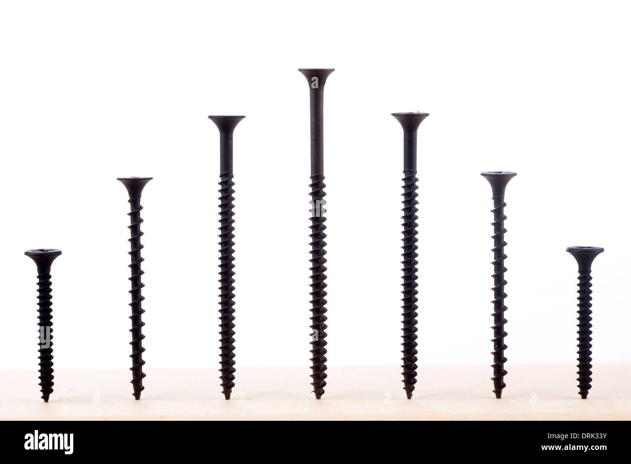 Black screws of different size on white background Stock Photo