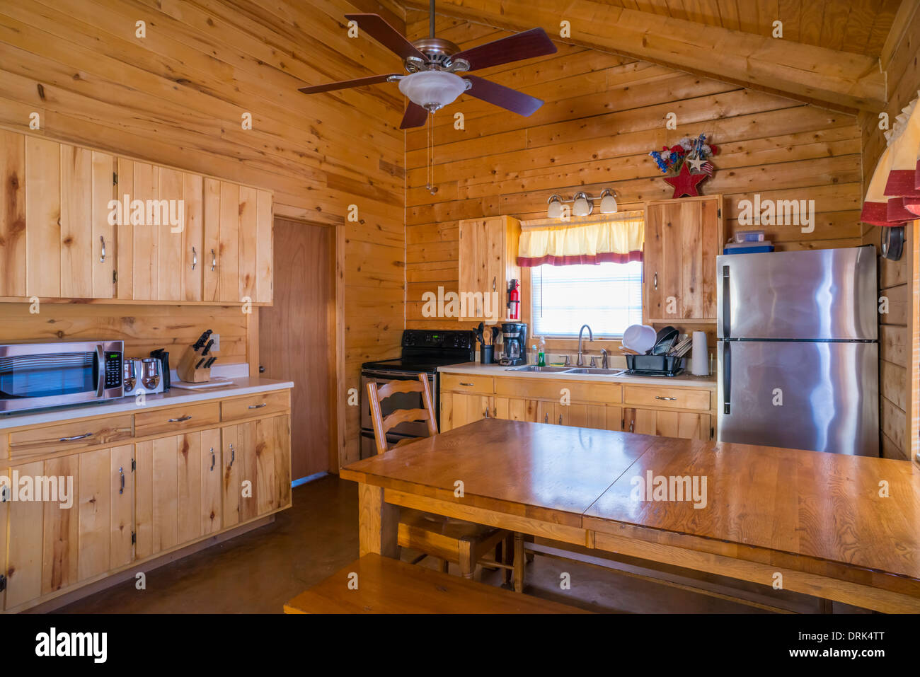 USA, Texas, rustic log home cabin interior with kitchen and dining area Stock Photo