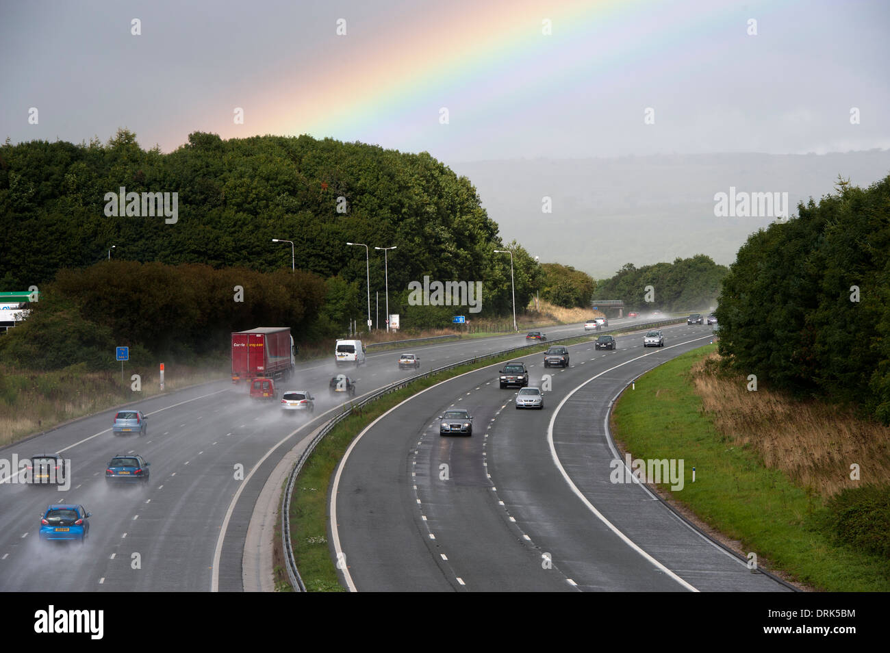 Rainbow over the M6 motorway after a sudden autumn rain shower. Cumbria. Stock Photo