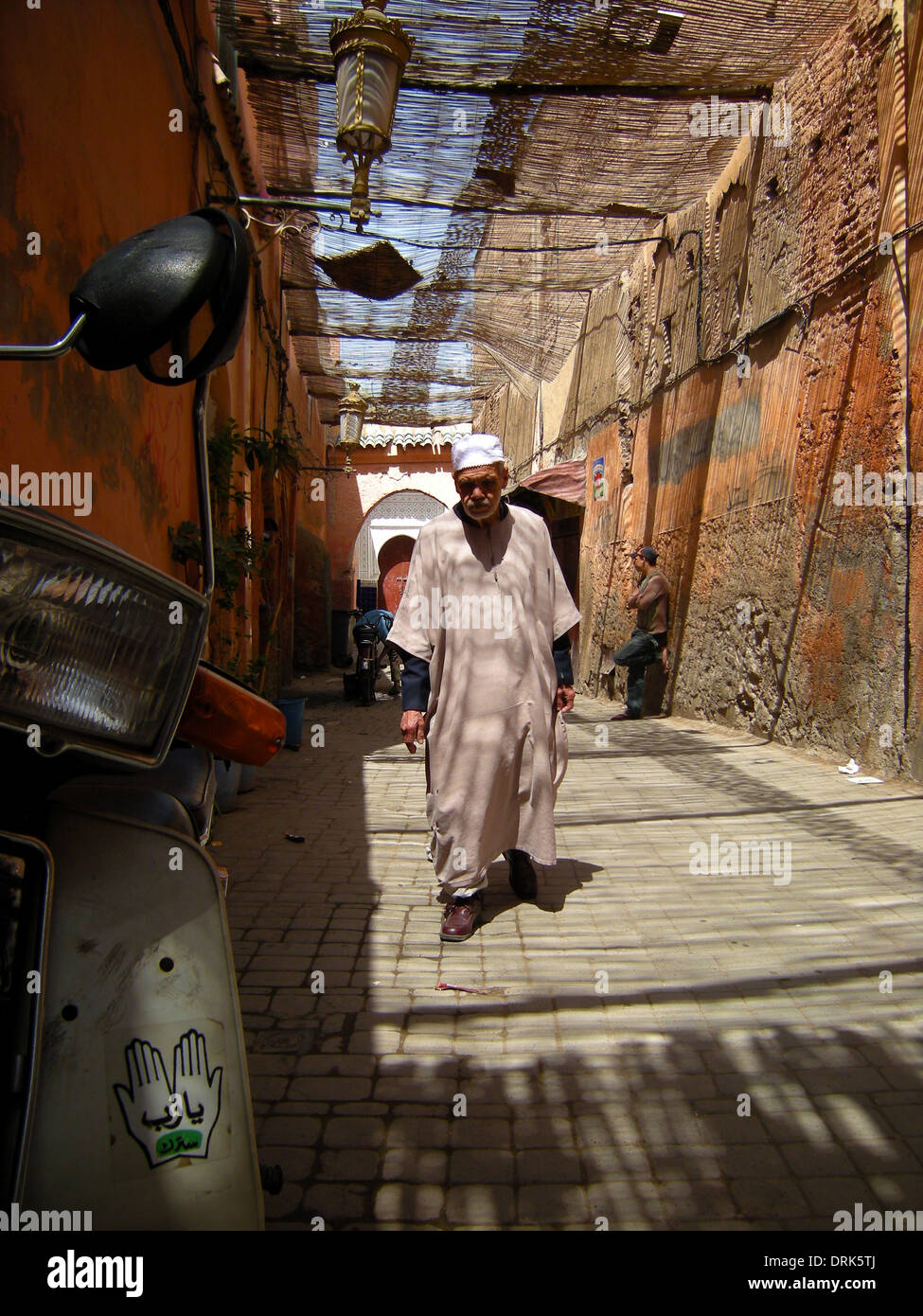 Marrakechi's go about their daily business in a street scene typical of that found in the city's canopied medina, Marrakech, Stock Photo