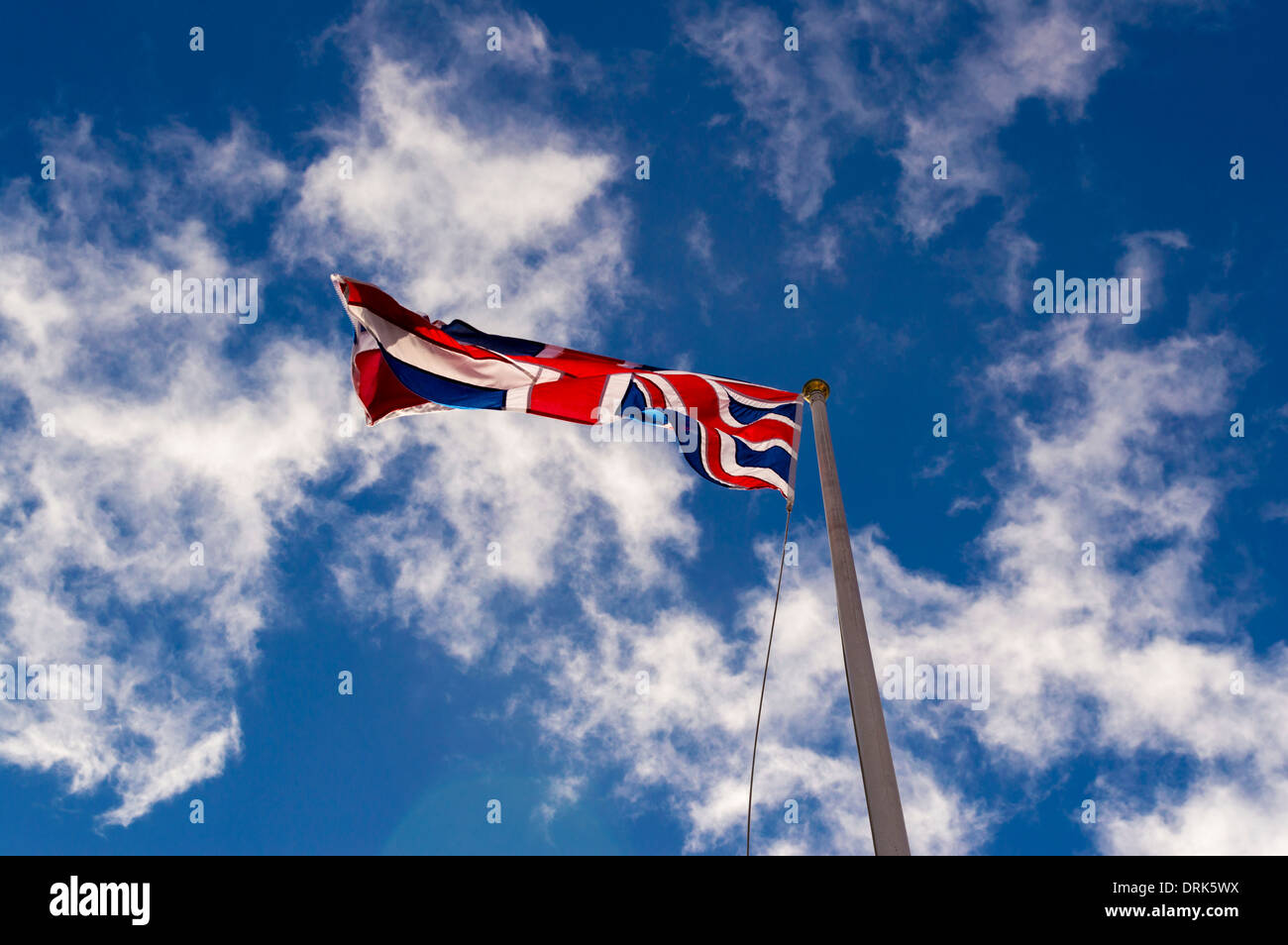 Union Jack flag blowing in wind seen from below Stock Photo