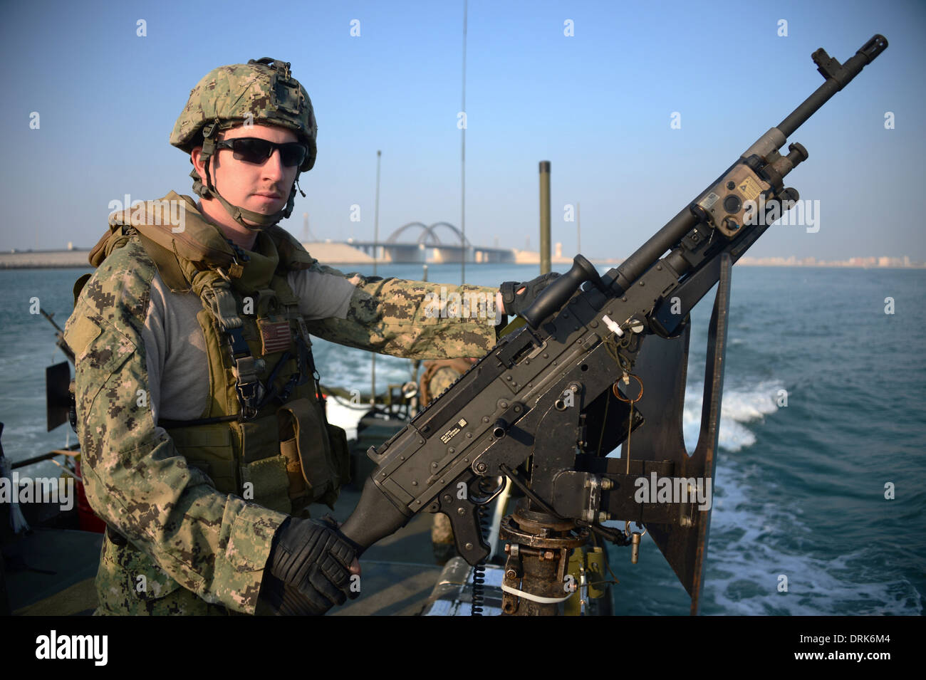 A US Navy riverine commando mans an M240B machine gun during a training exercise in the Arabian Gulf January 21, 2014 in Bahrain. Stock Photo