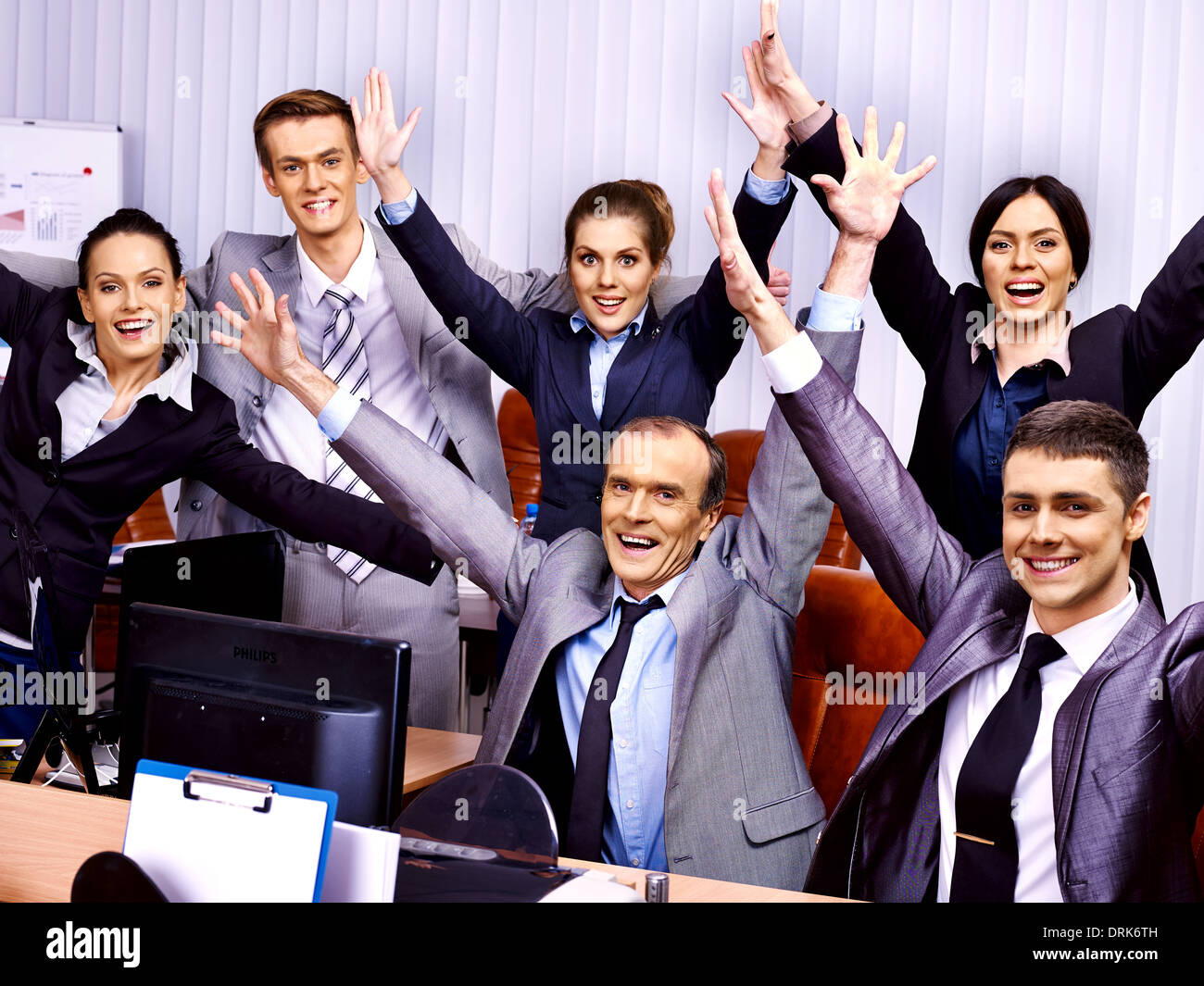Group business people with hand up in office Stock Photo - Alamy