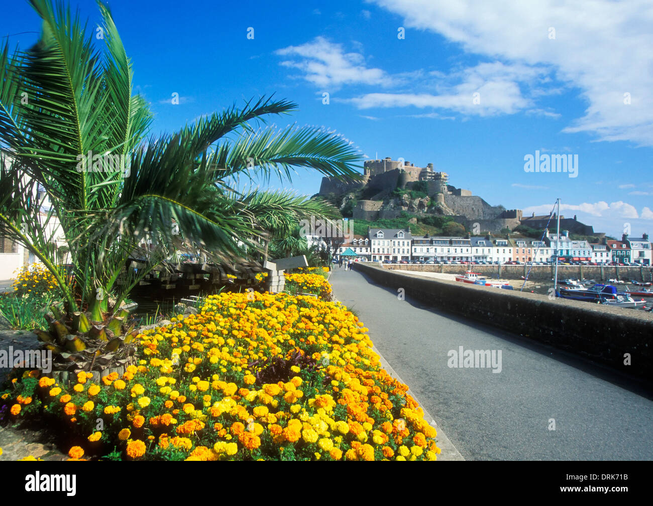 Mont Orgueil castle Gorey bay with colourful flower beds and promenade