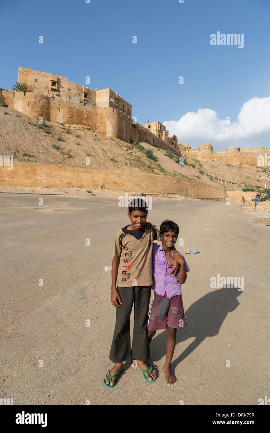 Two young Indian children posing for camera in front of theJaisalmer fort in the Thar desert of Rajasthan, India Stock Photo