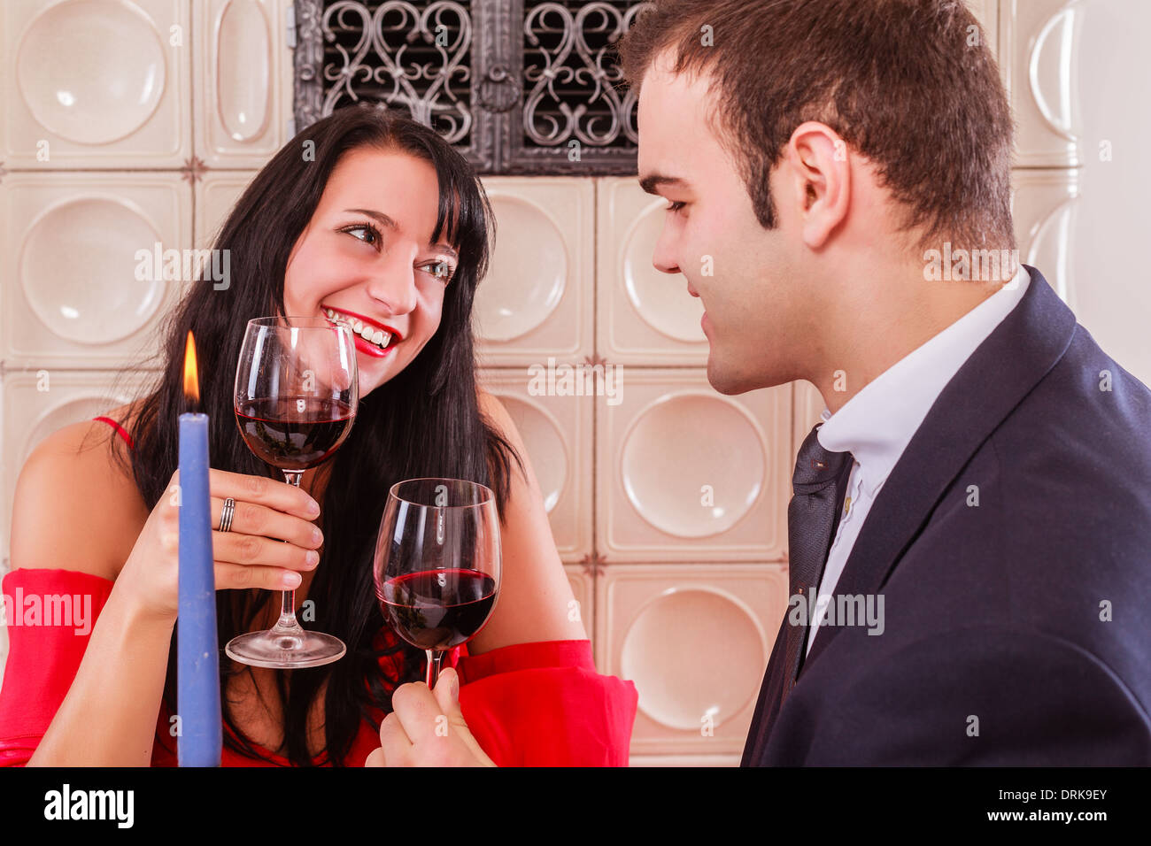 Romantic young couple drinking red wine Stock Photo - Alamy