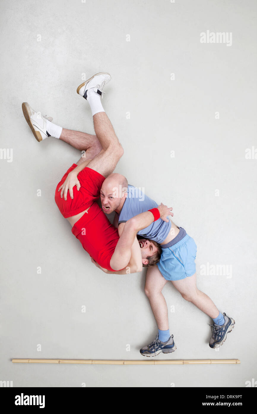 Two men wrestling Stock Photo