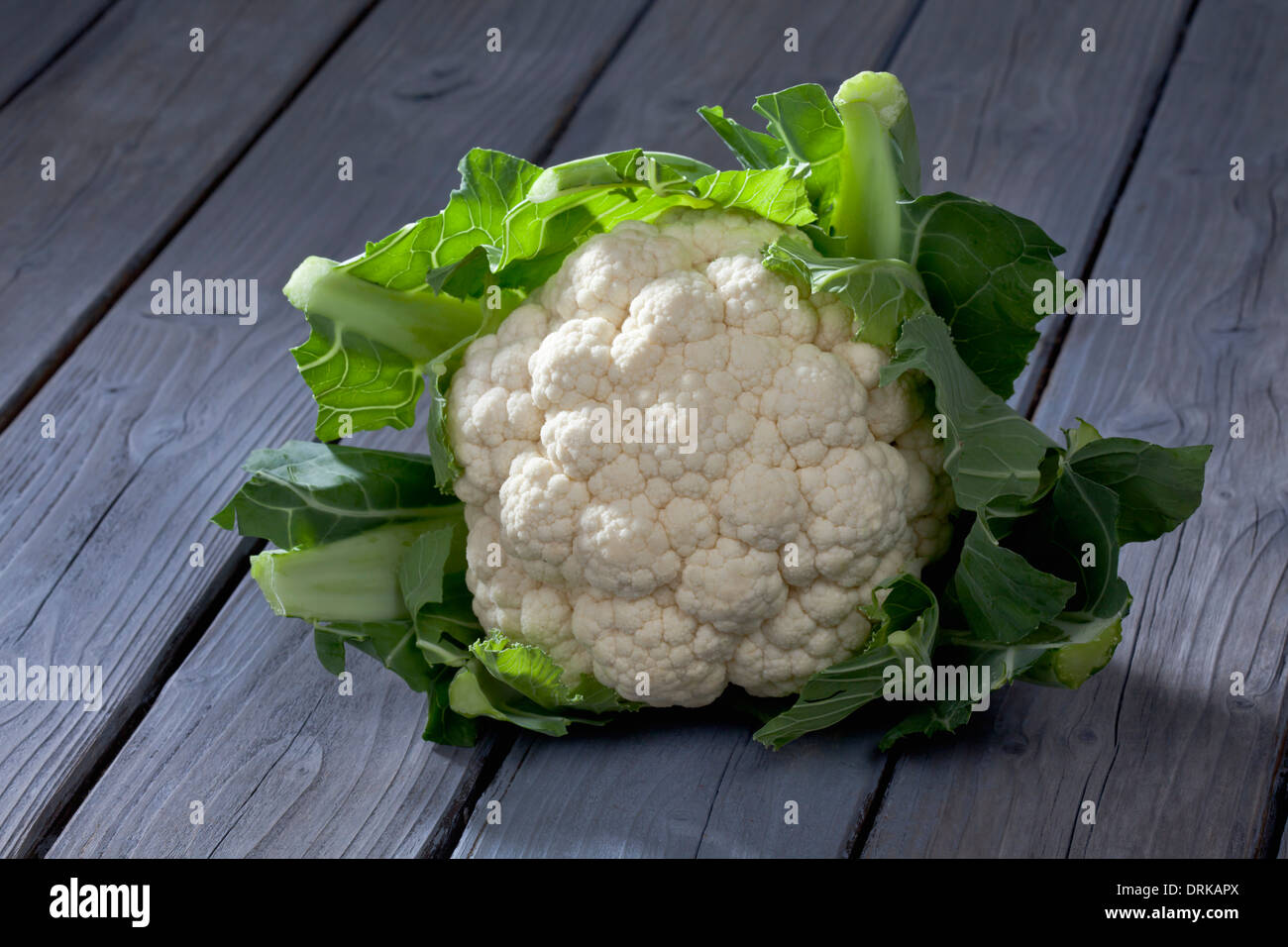 Cauliflower (Brassica oleracea var. botrytis L.) on grey wooden table