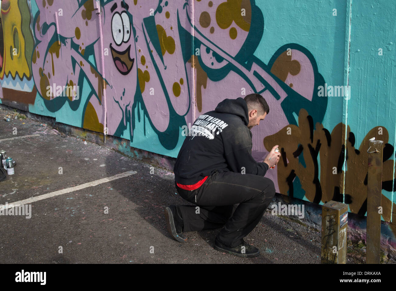 Graffiti artist painting wall. Street art Stock Photo - Alamy