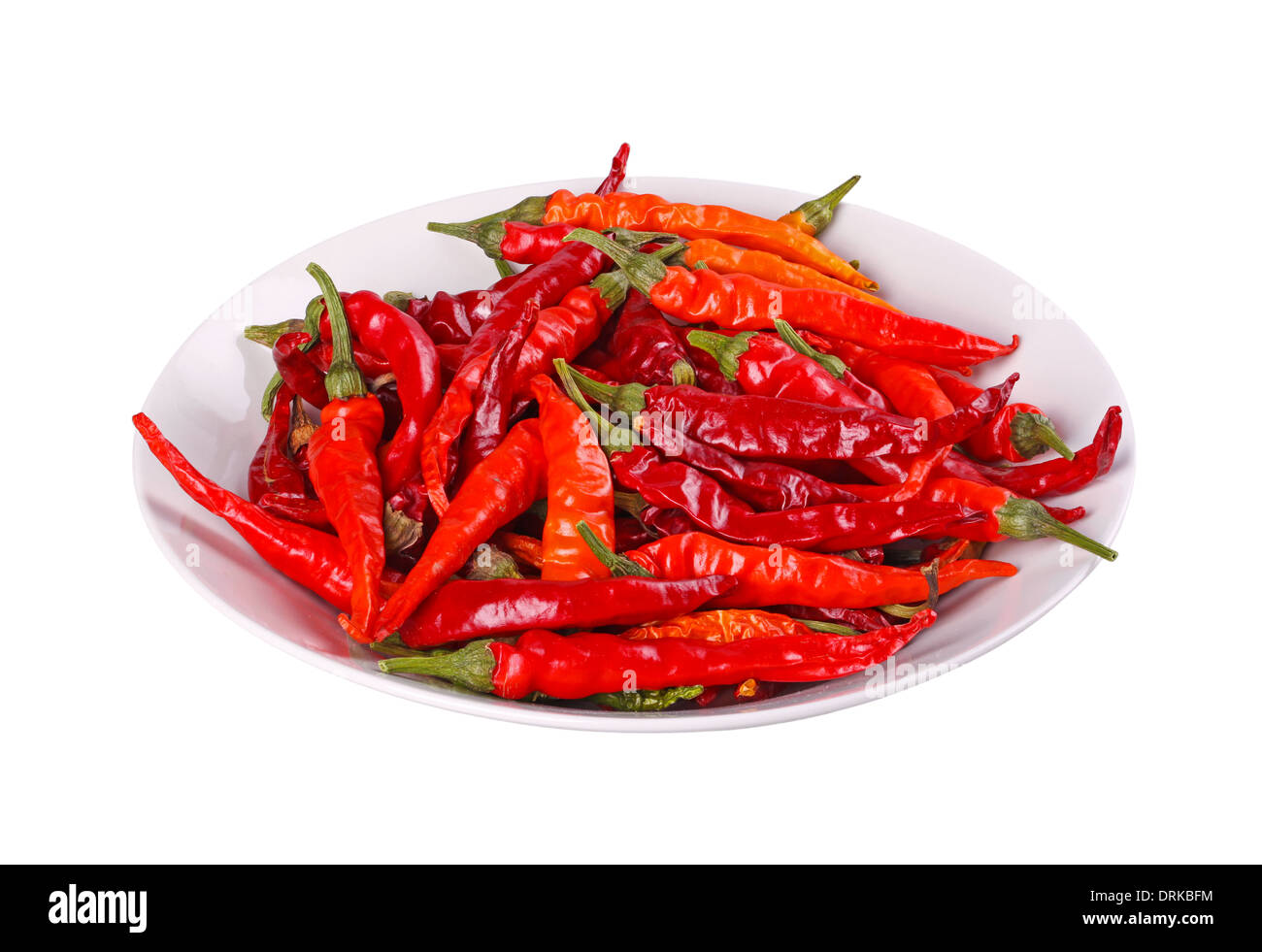 Bowl full of hot, red cayenne chili peppers (Capsicum annuum) isolated against a white background Stock Photo