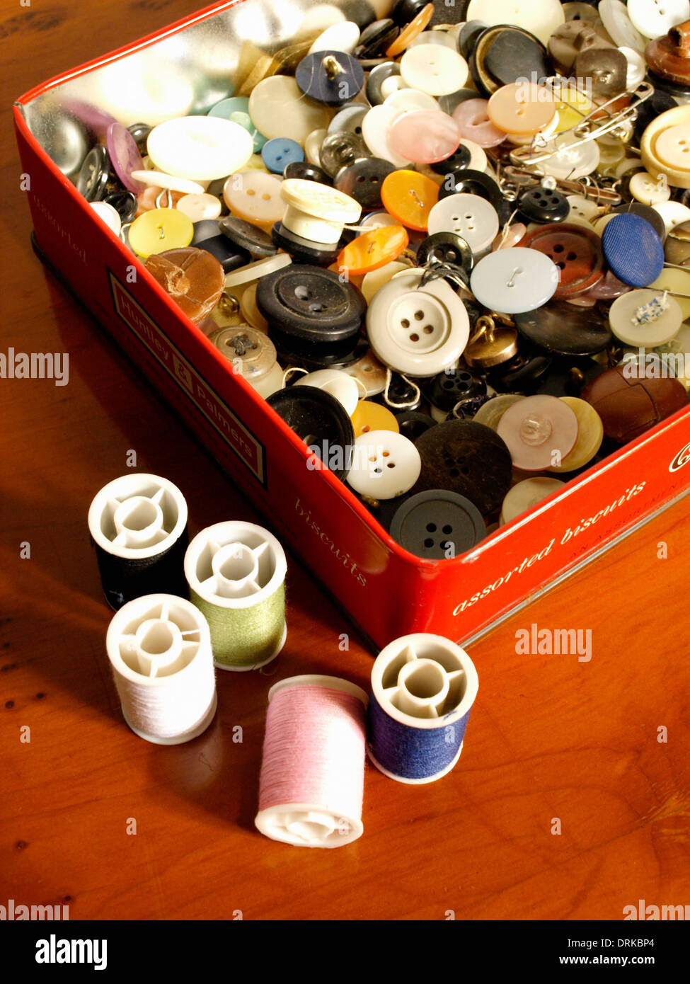 Tin of buttons and cotton reels Stock Photo
