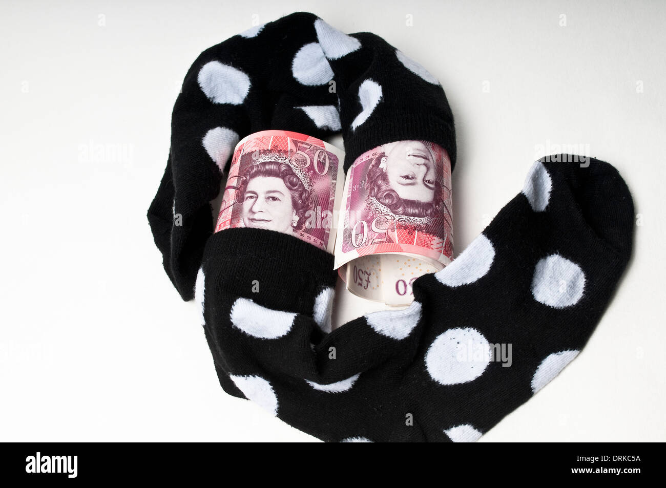 Fifty pound banknotes stuffed in a pair of socks Stock Photo