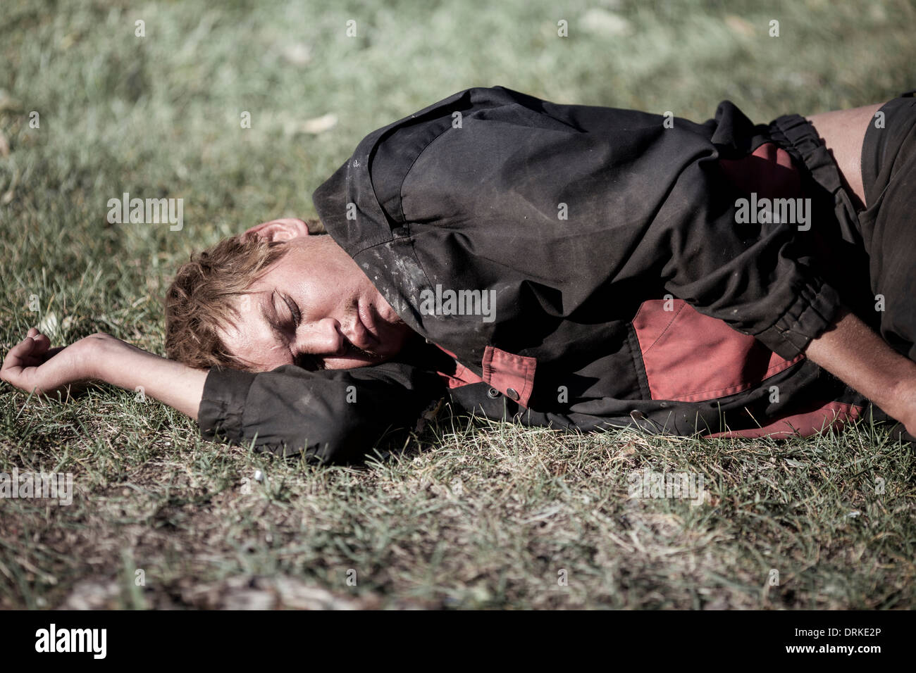 young homeless man sleeping , selective focus on eye Stock Photo