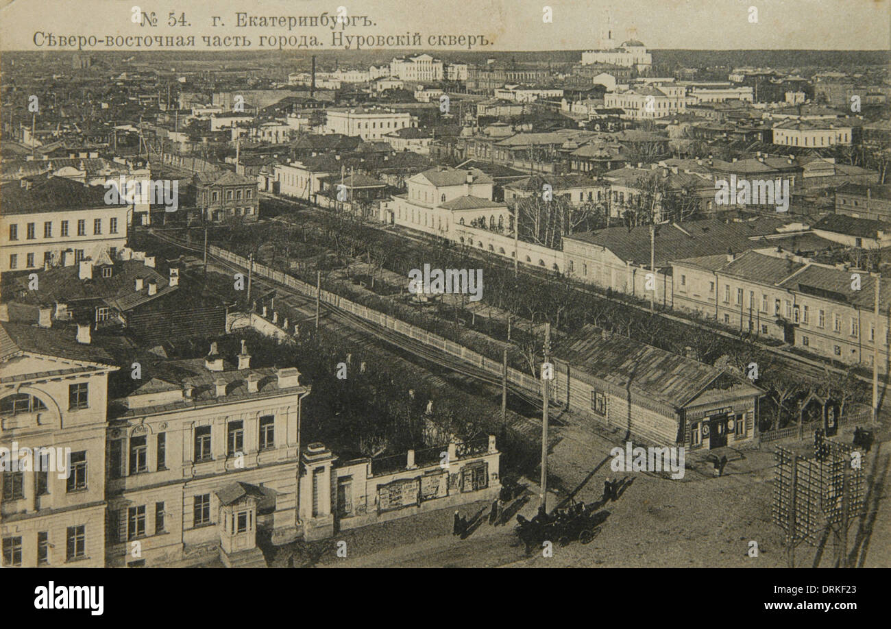 Aerial view of Yekaterinburg, Russian Empire. Black and white vintage photograph by Russian photographer Veniamin Metenkov dated from the beginning of the 20th century issued in the Russian vintage postcard published by Veniamin Metenkov himself in Yekaterinburg. Text in Russian: Yekaterinburg. North-Eastern part of the city. The Nurovsky Garden and Ascension Hill (Voznesenskaya gorka) with the Church of the Ascension (Voznesenskaya Church) are seen in the postcard. The view from the bell tower of St Catherine's Cathedral. Courtesy of the Azoor Postcard Collection. Stock Photo