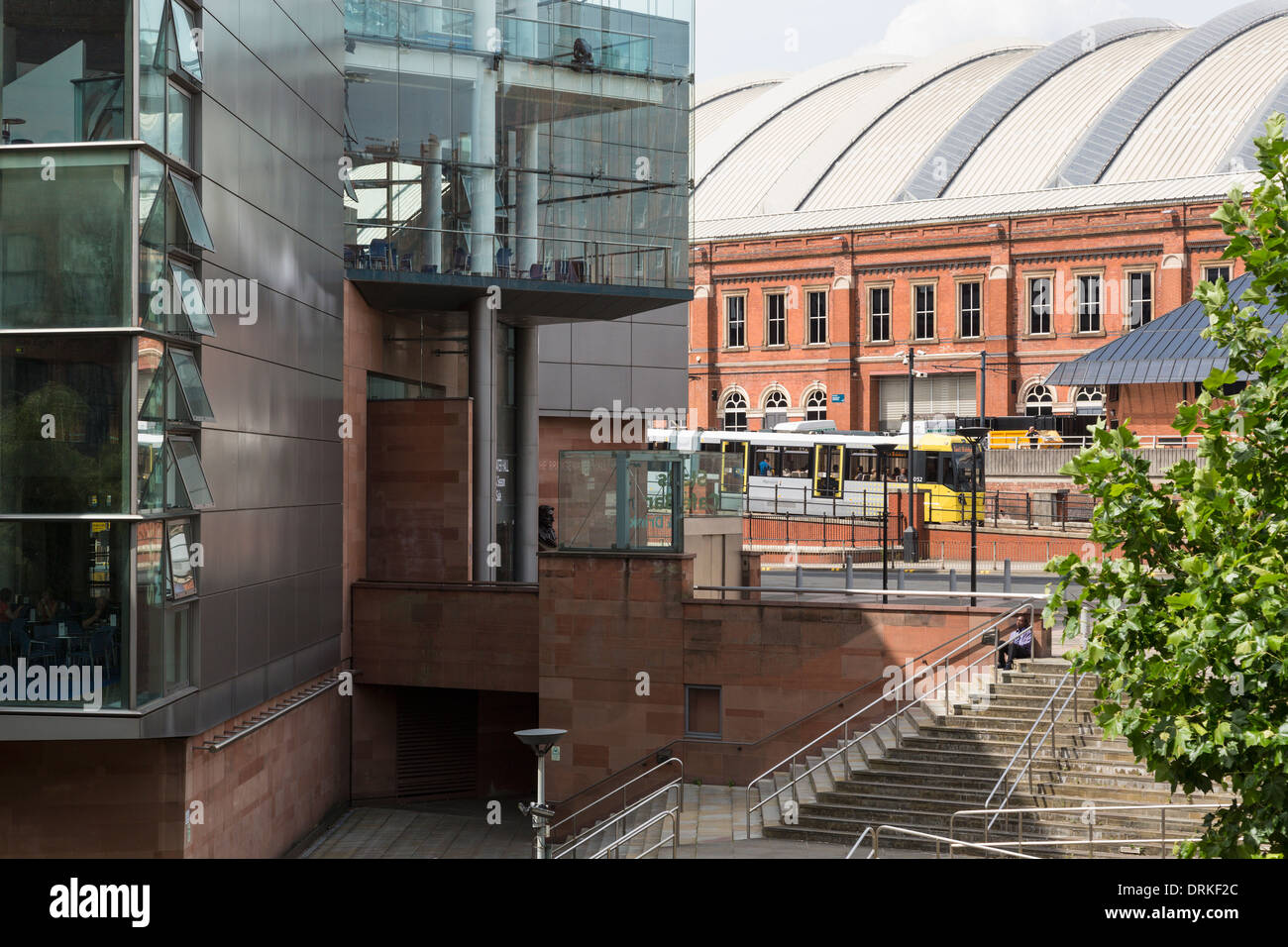 Tram passes Bridgewater Hall and G-Mex centre, Manchester, England Stock Photo