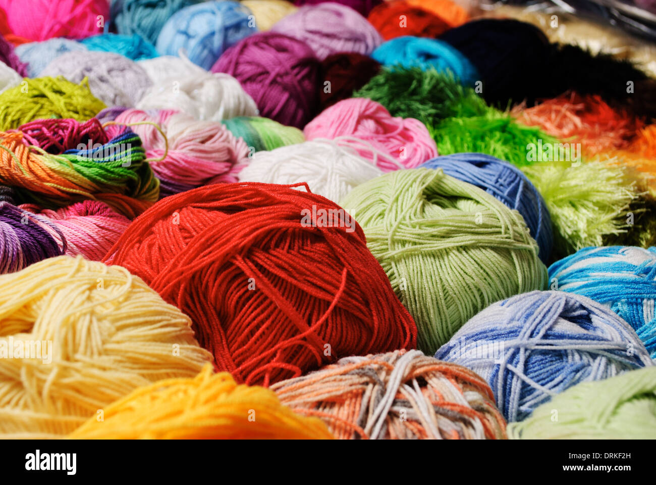 Different color threads on rows in the store Stock Photo - Alamy