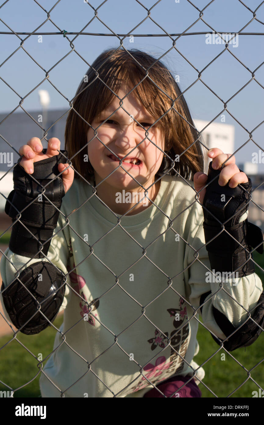 portrait of little girl and fence Stock Photo - Alamy