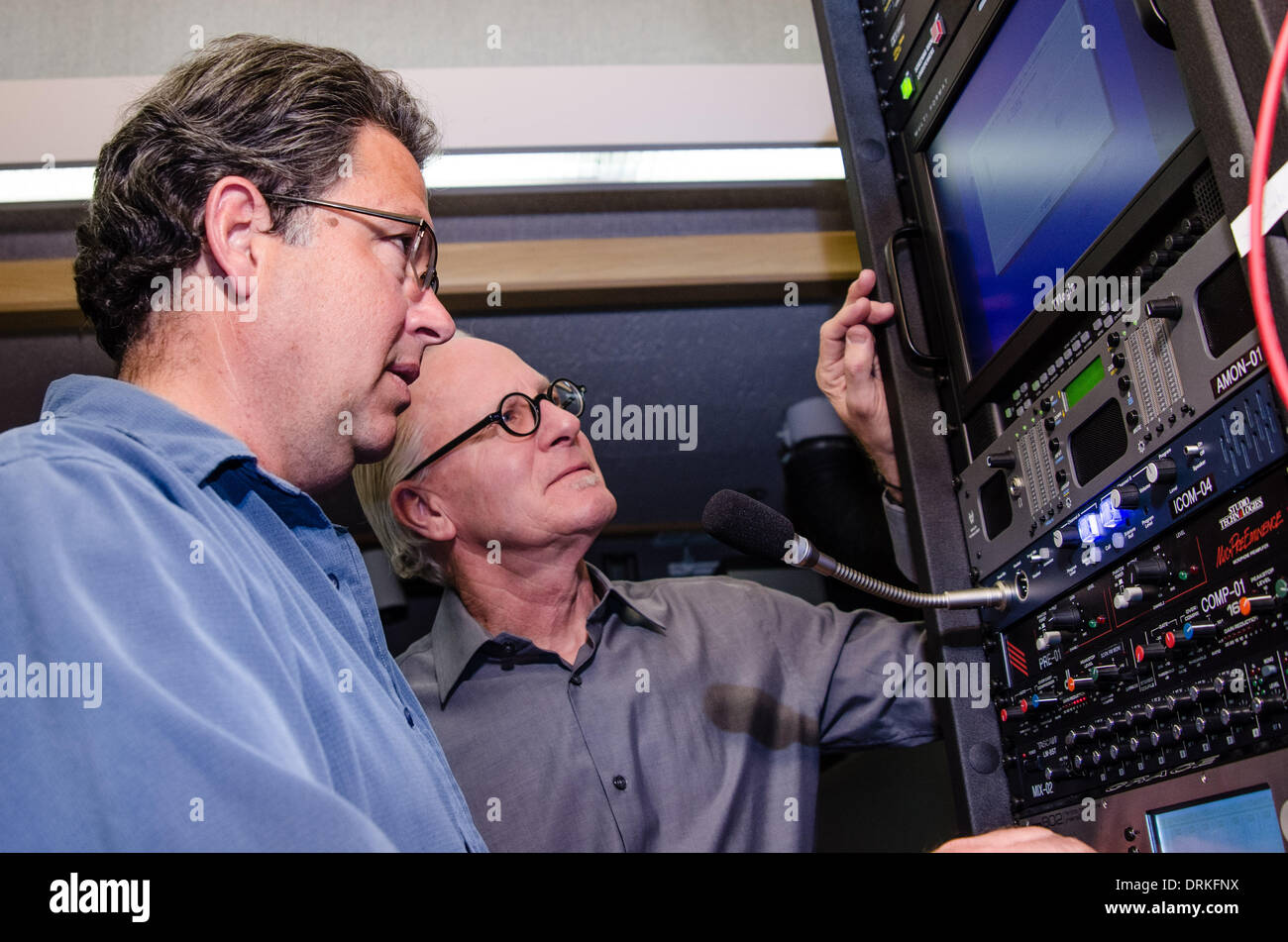 Working on the company's new audio system Dolby Atmos, engineers Kevin Perry (left) and Thomas Bruchs check the settings of a sound mixing panel. The engineers work at company headquarters in San Francisco, testing equpment in an ultra-modern screening ro Stock Photo