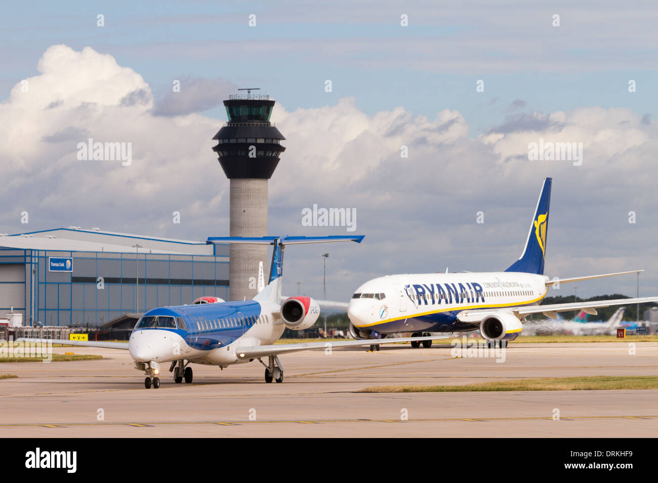 BMI Embraer taxis past control tower for take off at Manchester Airport Stock Photo