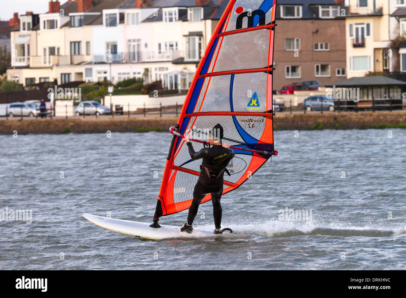 Male windsurfer sails on marine lake Stock Photo