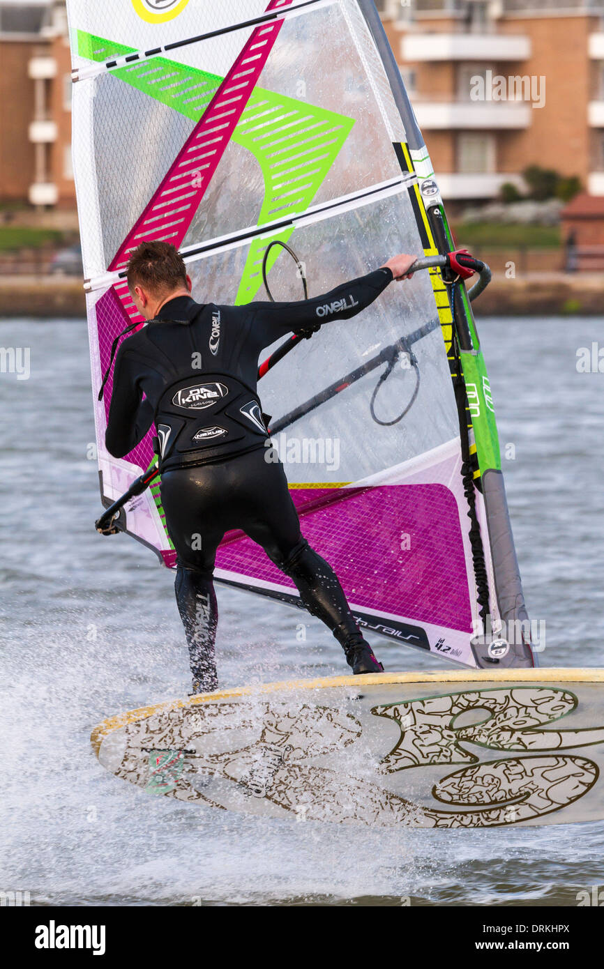 Male windsurfer makes trick turn Stock Photo