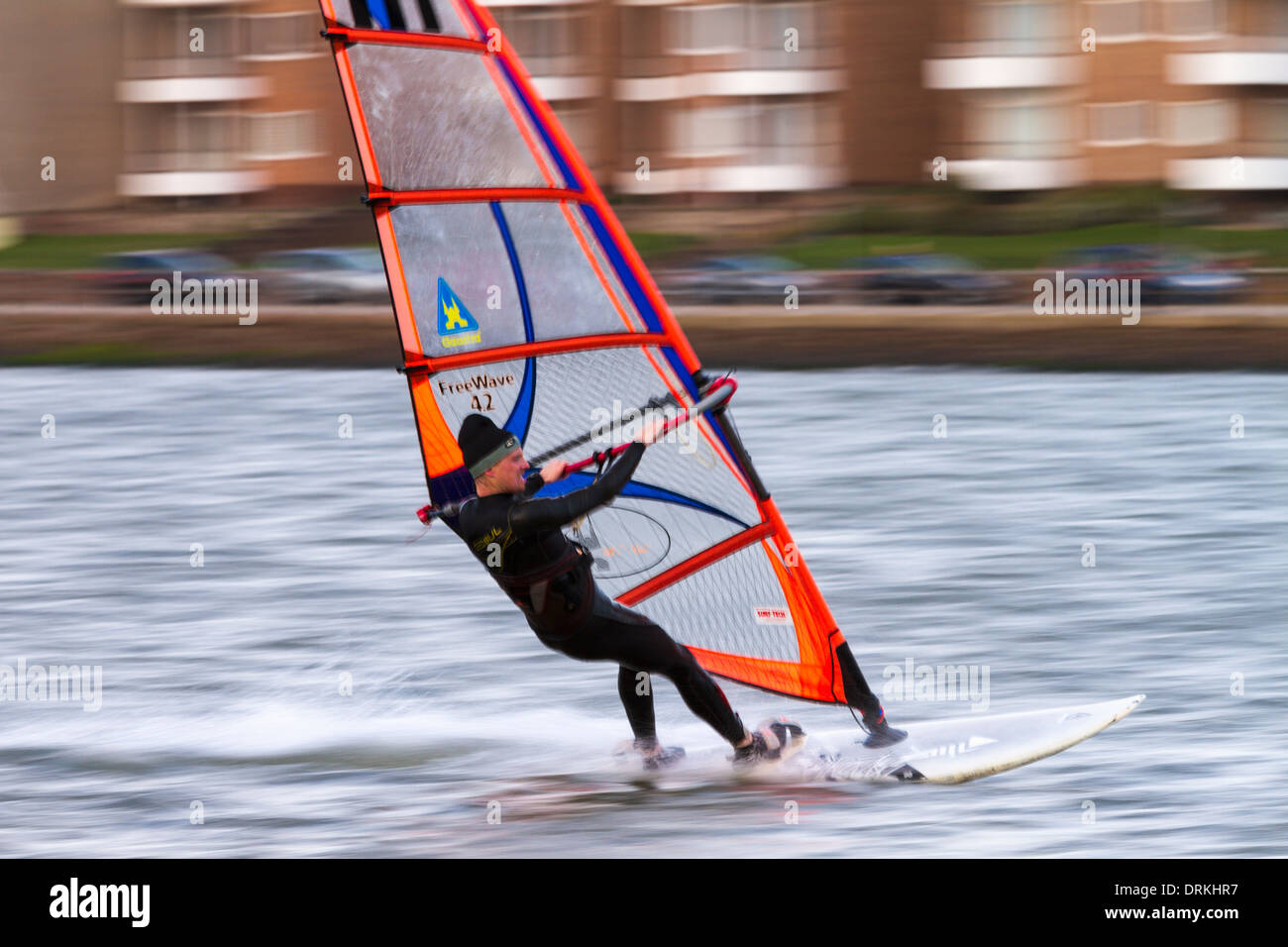Male windsurfer sails on marine lake Stock Photo