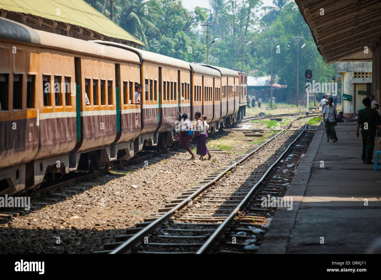 Rushing to catch a train in Yangon, Myanmar Stock Photo