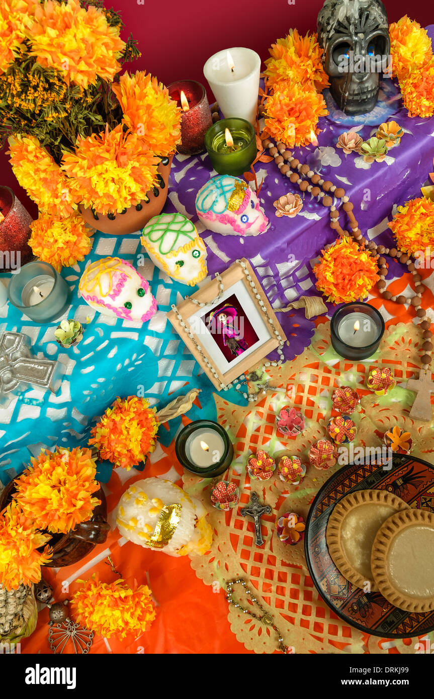 Traditional Mexican Day of the dead altar with photo frame, sugar skulls  flowers and candles Stock Photo - Alamy