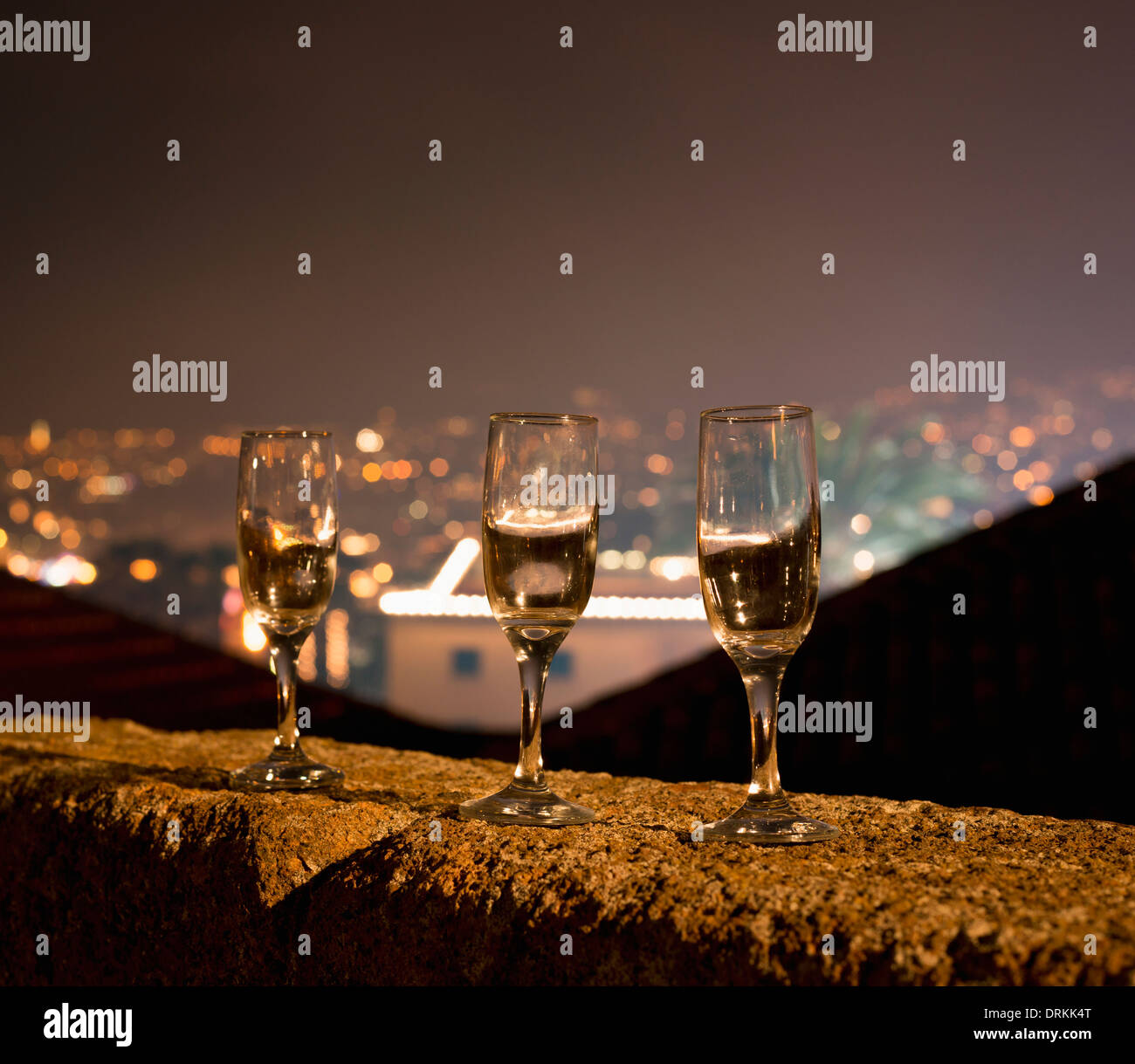 Portugal, Madeira, Funchal, Forte de Sao Tiago, three empty champagne glasses standing on balustrade at New Year's Eve Stock Photo