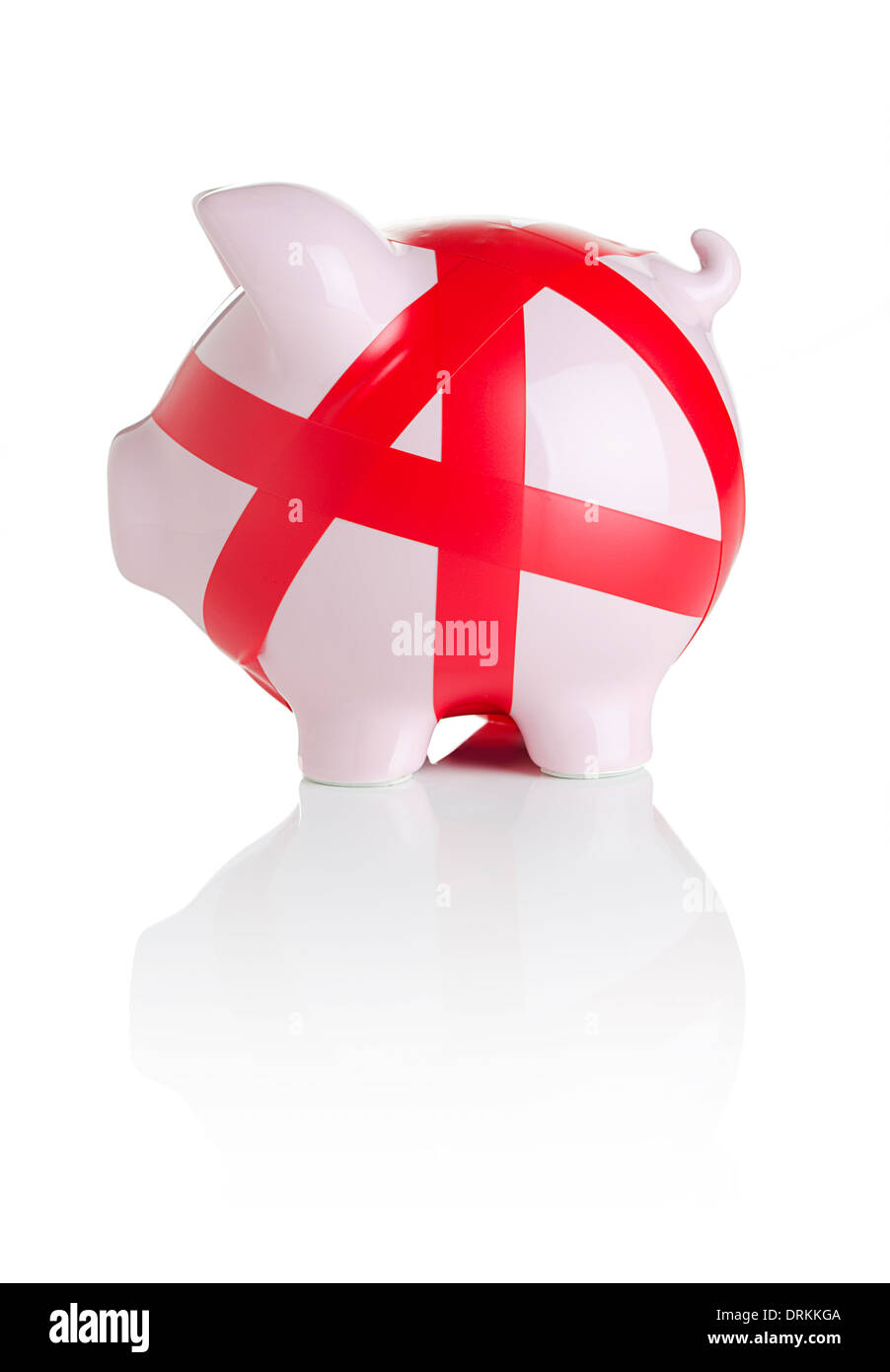 Piggy bank wrapped with red tape Stock Photo