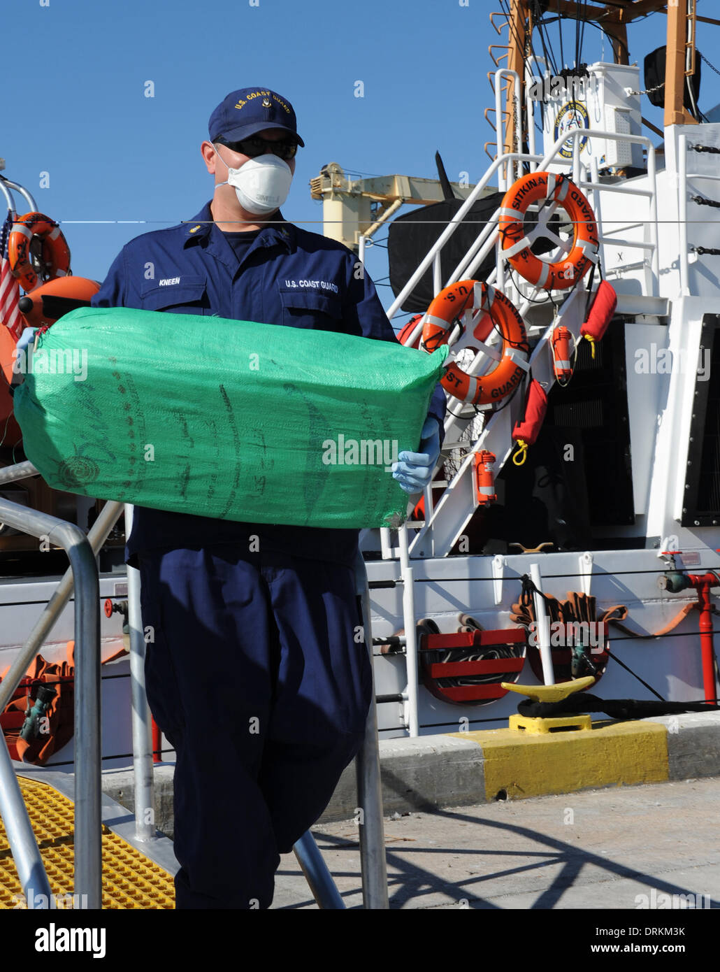 US Coast Guard Chief Petty Officer Raymond Kneen offloads 2,500 pounds of cocaine worth an estimated $37 million wholesale value January 28, 2014 in Miami Beach, FL. The contraband was seized in a multi-national counter-drug operation south of the Dominican Republic. Stock Photo