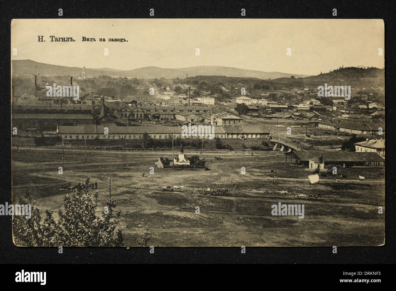 Copper smelting plant in the town of Nizhny Tagil in the Ural Mountains, Russian Empire. Black and white vintage photograph by an unknown photographer dated from the beginning of the 20th century issued in the Russian vintage postcard published by M. Kampel, Moscow. Text in Russian: Nizhny Tagil. View of the plant. Nizhny Tagil is a city in Sverdlovsk region, Russia, located some 120 km from Yekaterinburg. Courtesy of the Azoor Postcard Collection. Stock Photo