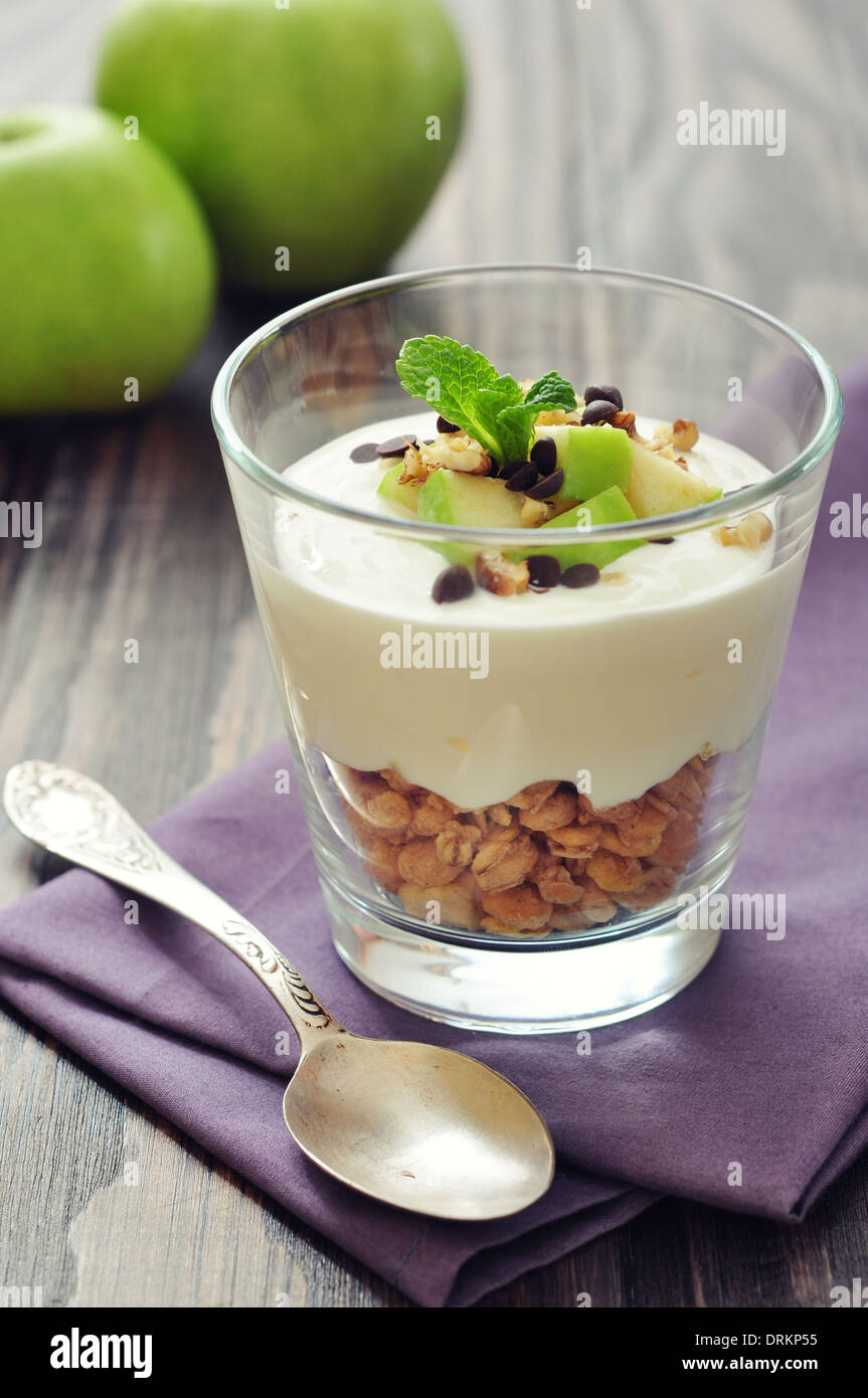 Homemade dessert with apple, nuts, yogurt and granola in glasses Stock Photo