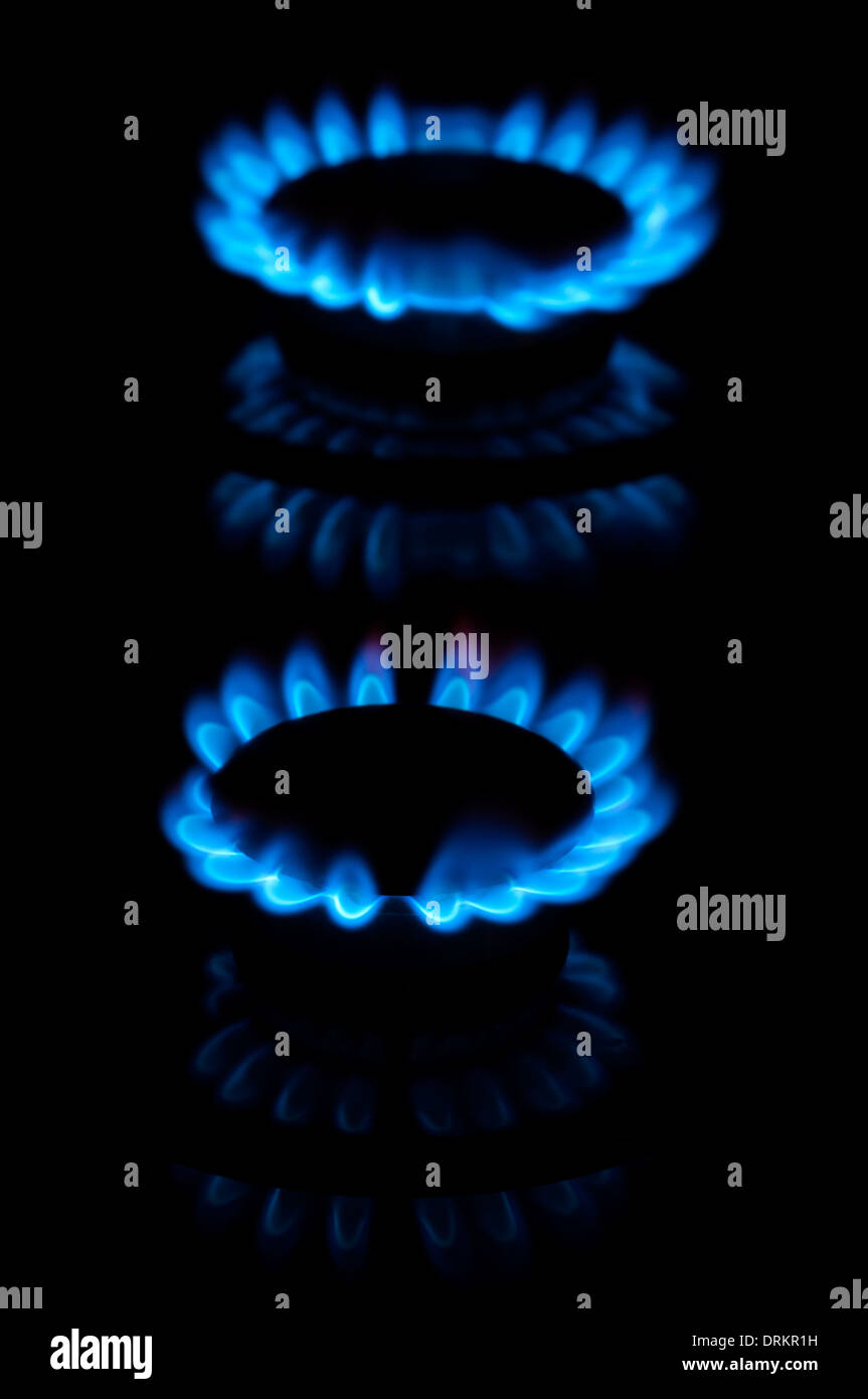 Blue gas flames from two stove burners in the dark Stock Photo Alamy