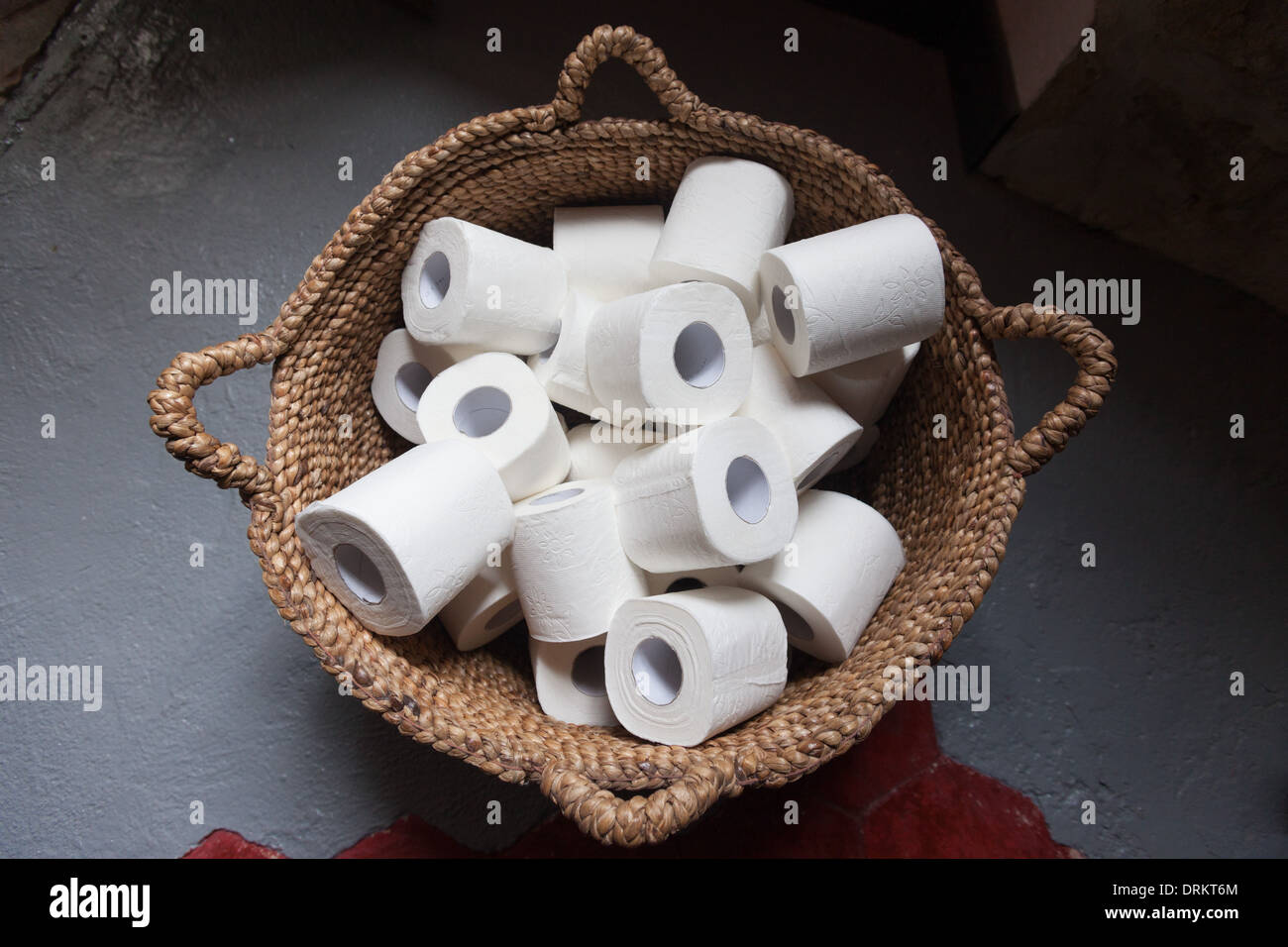 Toilet paper rolls in a basket. Stock Photo