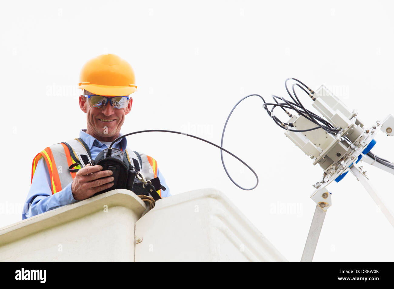 Communications engineer measuring signal level at low noise amplifiers and feedhorns at satellite dish Stock Photo