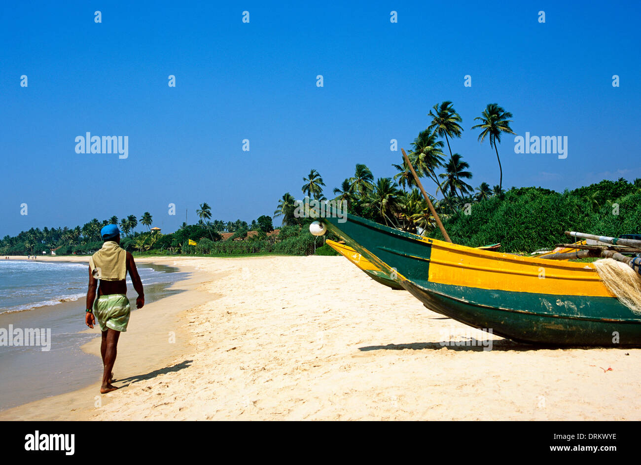 Local Man Walking Along The Beach In Stonetown Zanzibar Africa Stock Photo