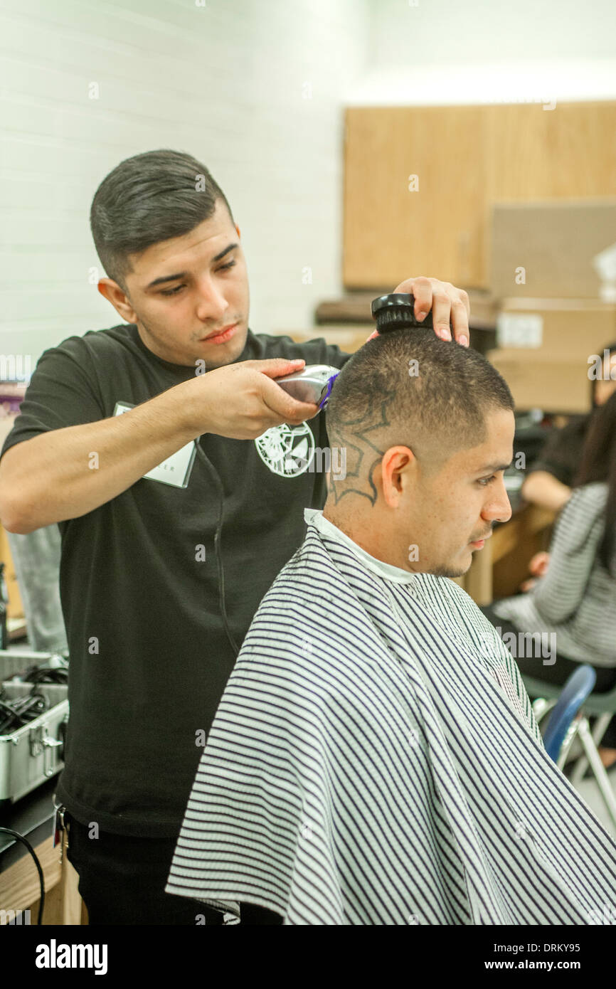 A man gets a haircut from Working Wardrobes, a organization helping the unemployed dress and groom for successful business job interviews in Southern California. The haircut is part of an "Employment Success Workshop." Stock Photo