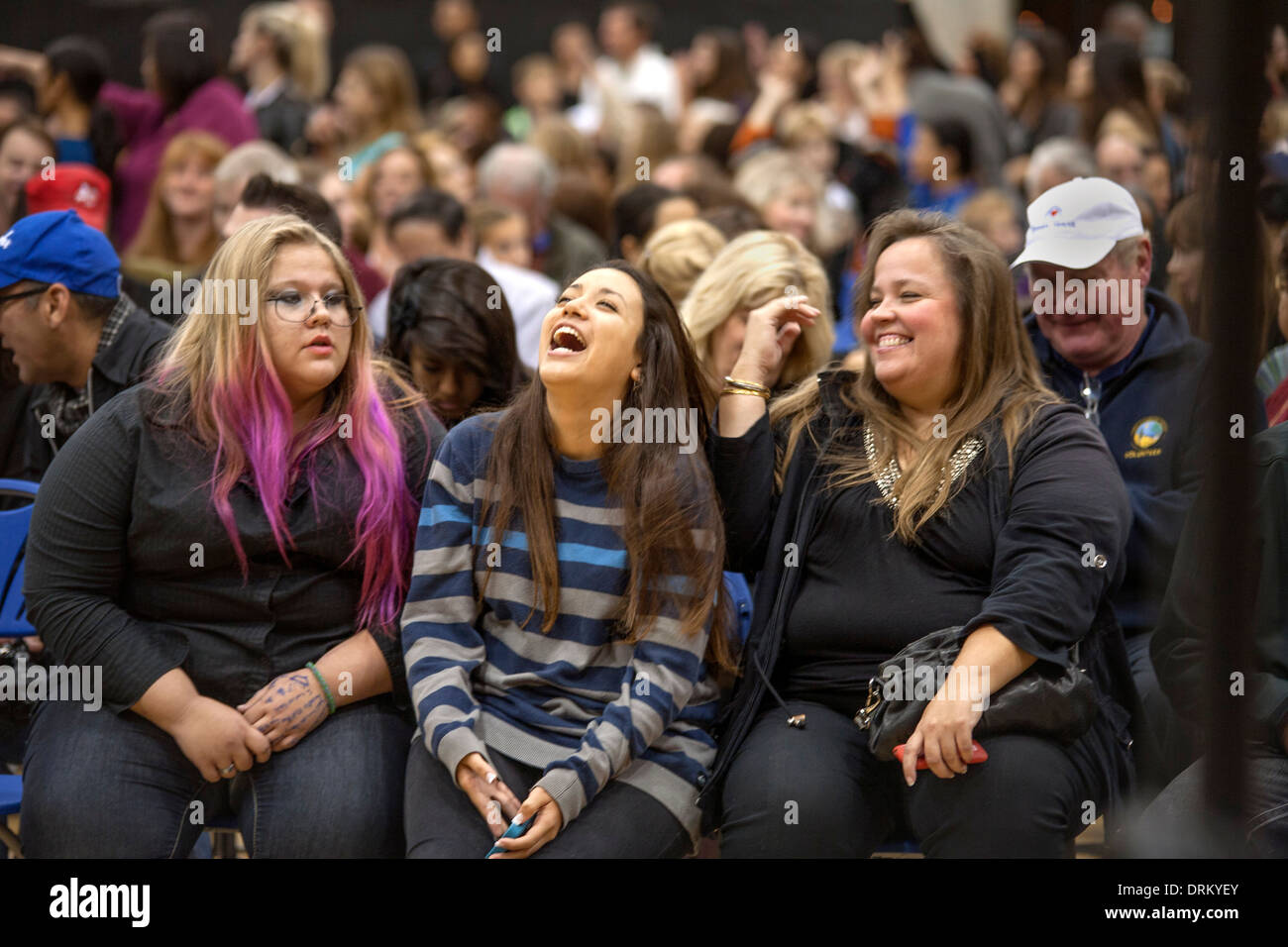 Two 'plus-size' teen girls share a laugh with a friend at a high school concert in Aliso Viejo, CA. Stock Photo