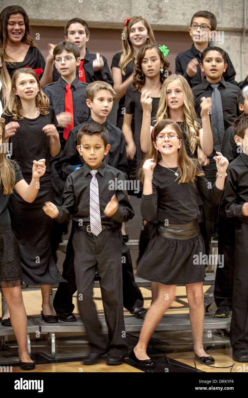 Multiracial middle school students sing Christmas carols at a school concert in Aliso Viejo, CA. Note matching black clothing. Stock Photo